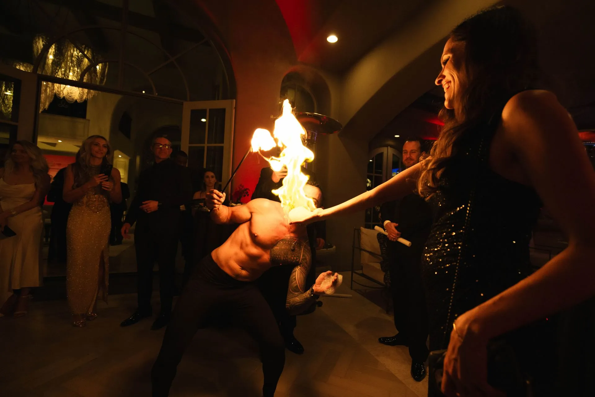 A man is holding a torch in his hand while a woman watches.