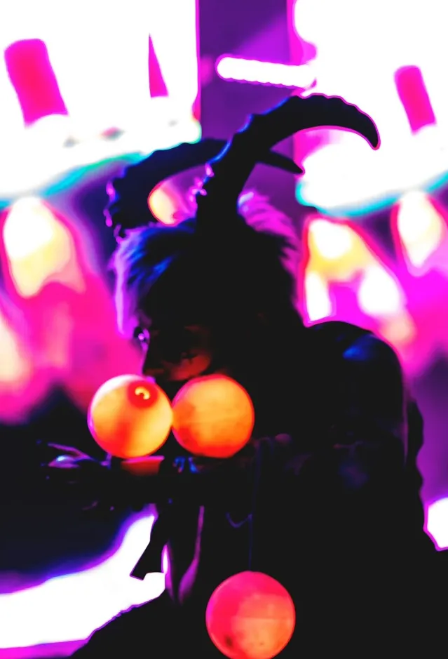 A woman holding LED poi with a colorful background.