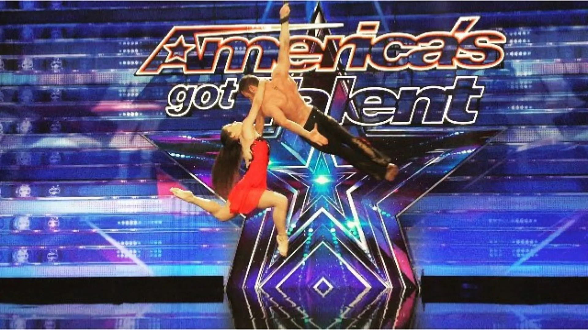A man and a woman are performing on a stage in front of a sign that says america 's got talent