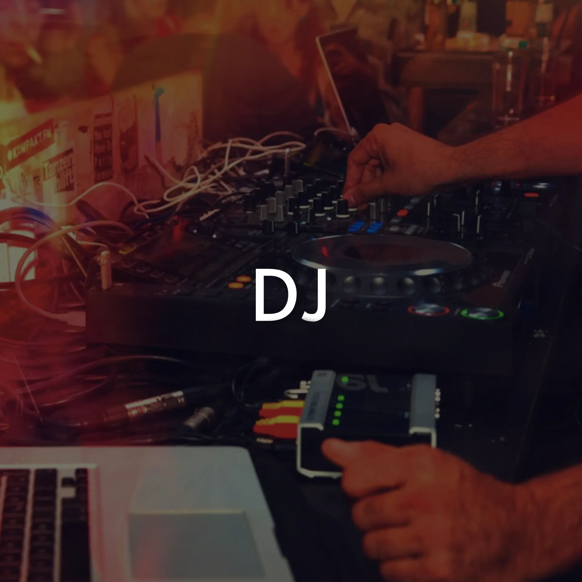 A person operating DJ equipment, with a laptop visible.