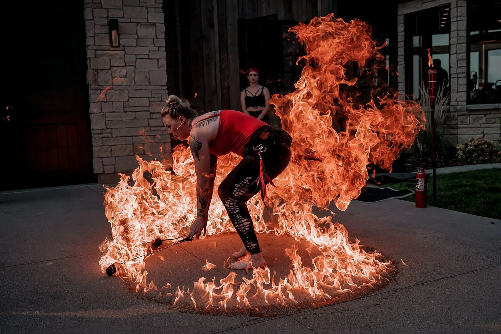 A woman is standing in a circle of fire.