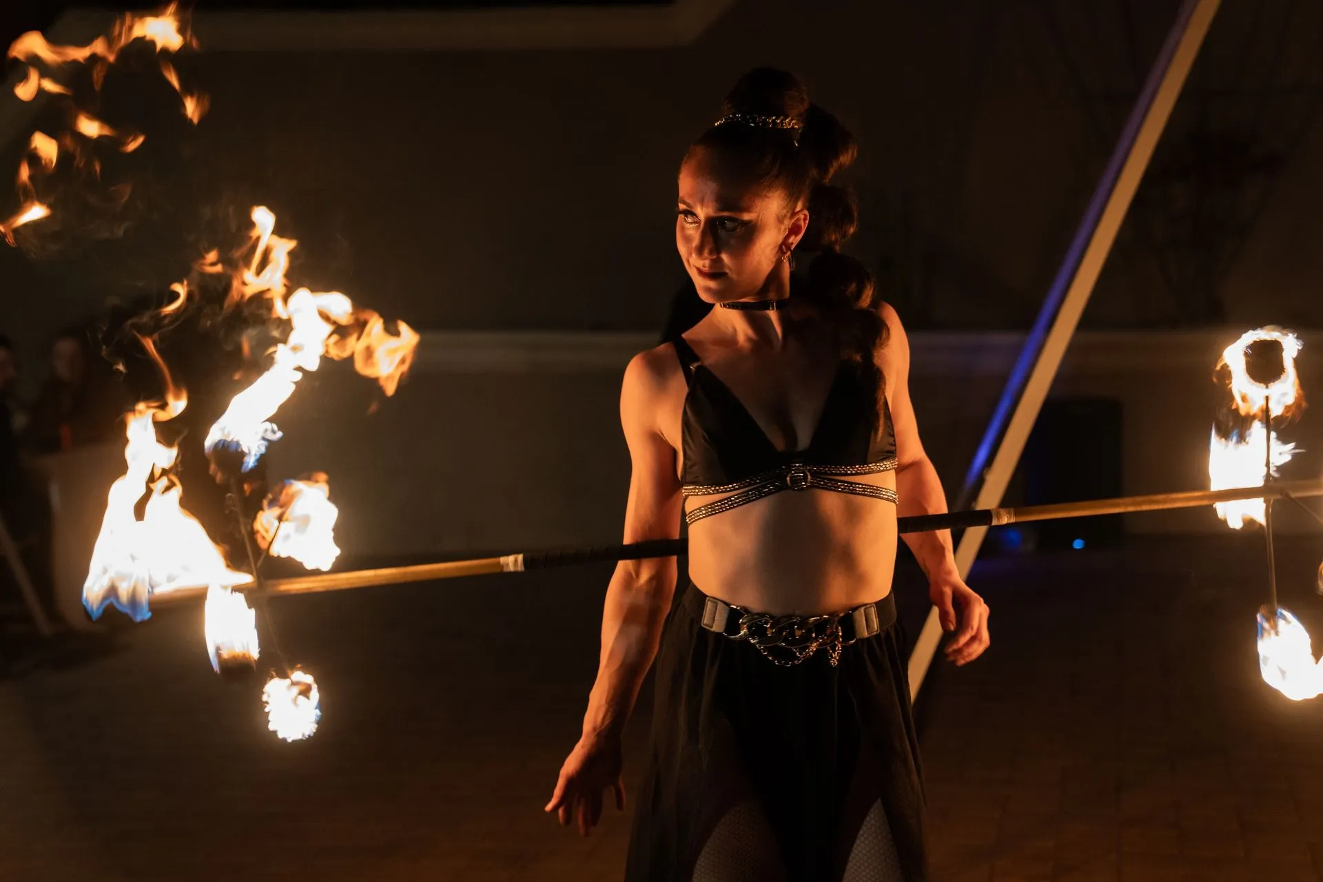 A woman performing with a dragon staff in a show.