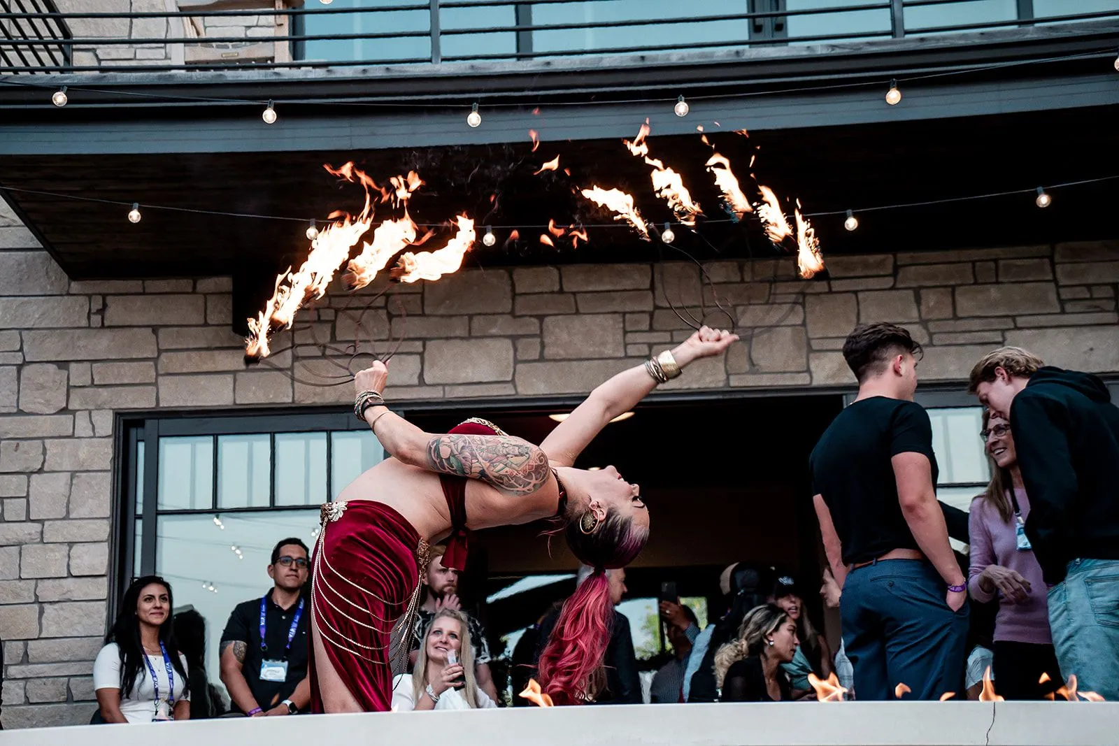 A woman is doing a handstand in front of a crowd of people.