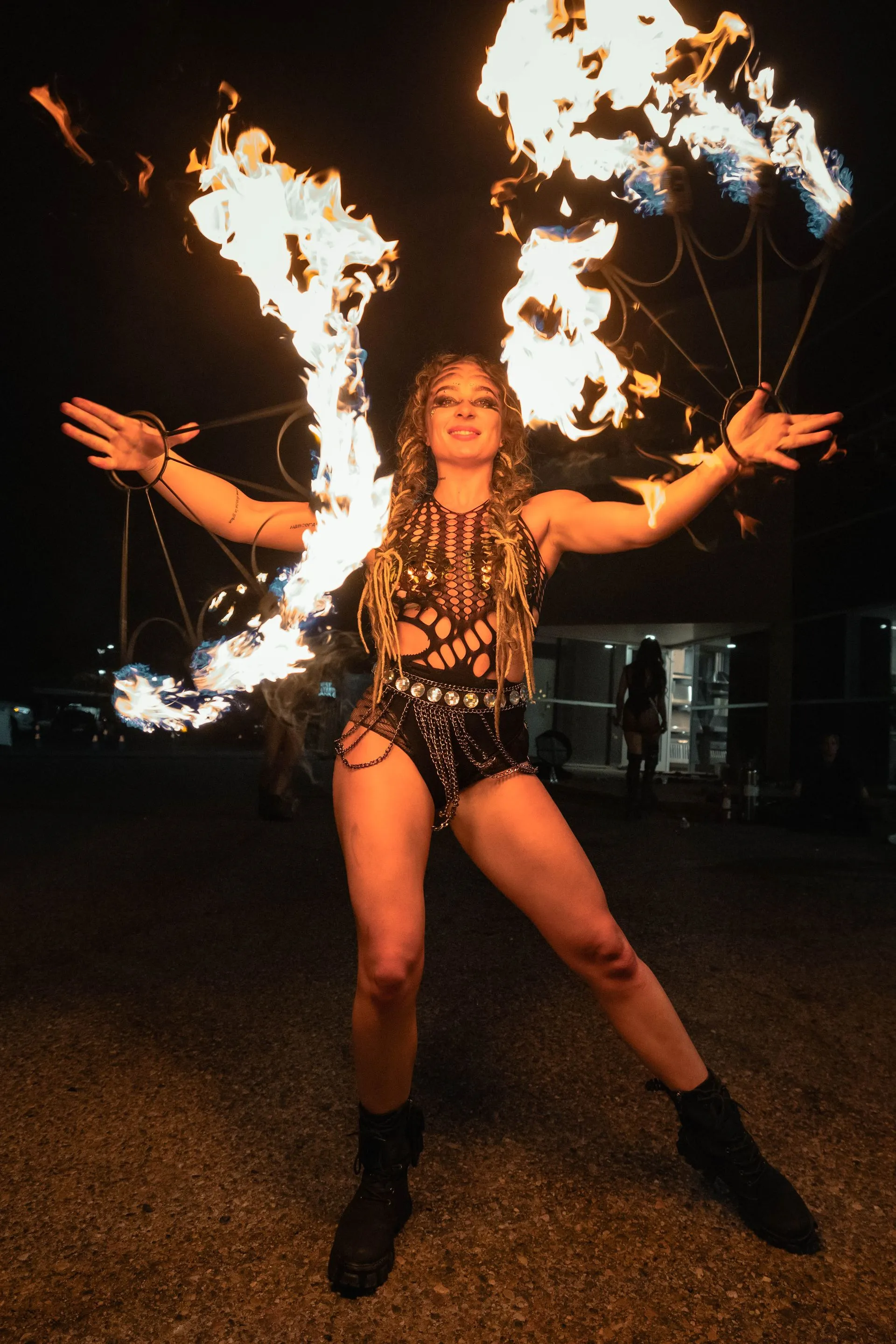A woman in a costume is holding a fireball in her hands.