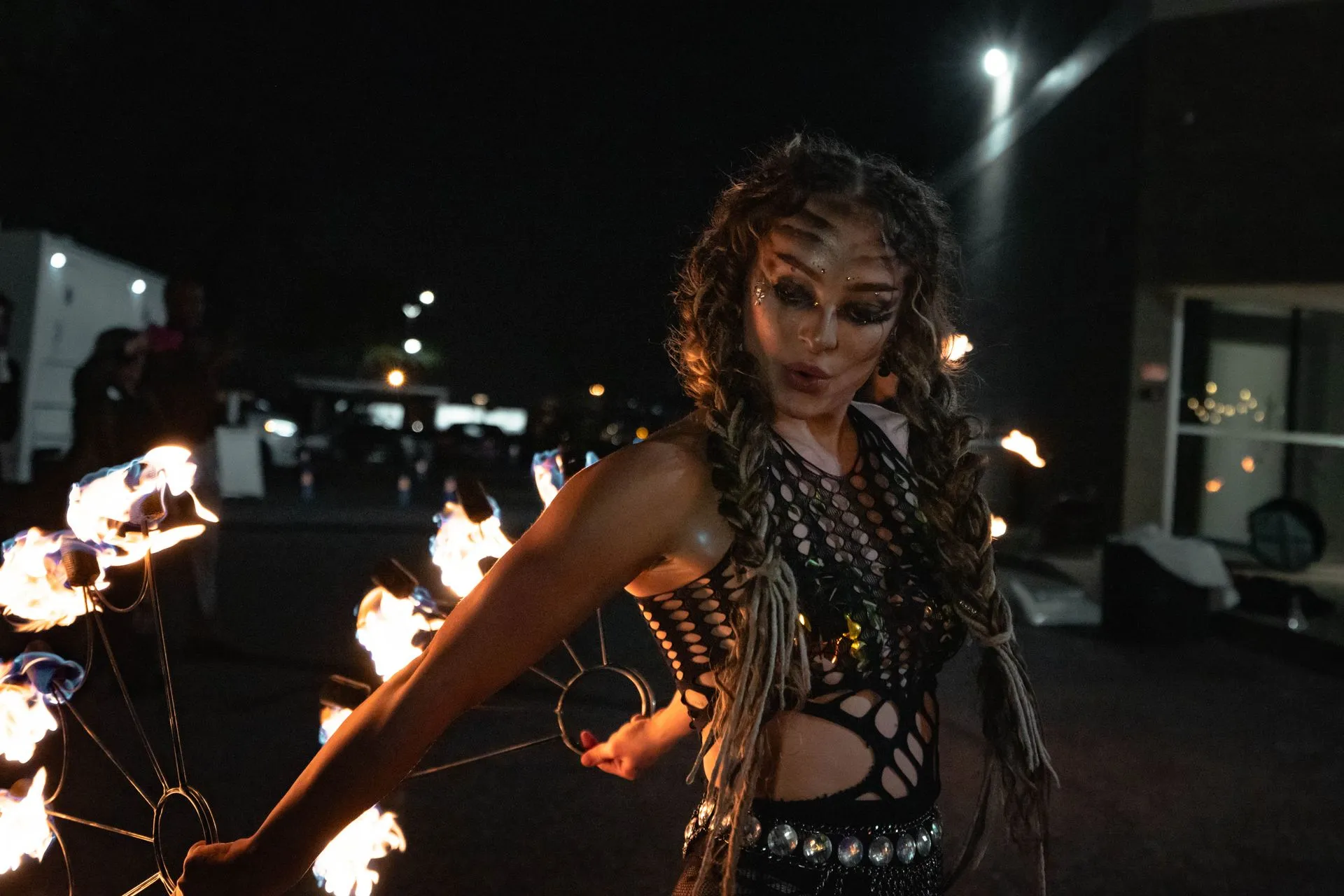 A woman is holding a bunch of fire in her hands