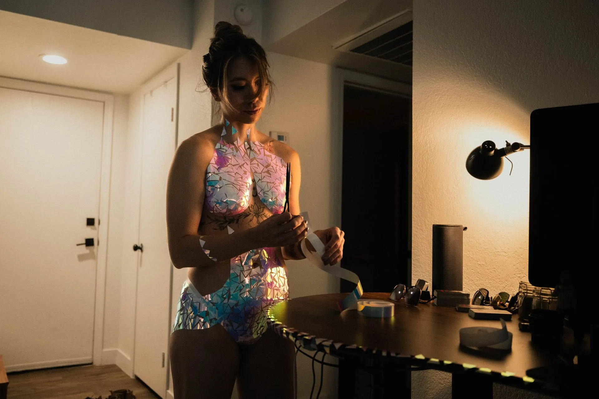 A woman is standing in a room covered in tape.
