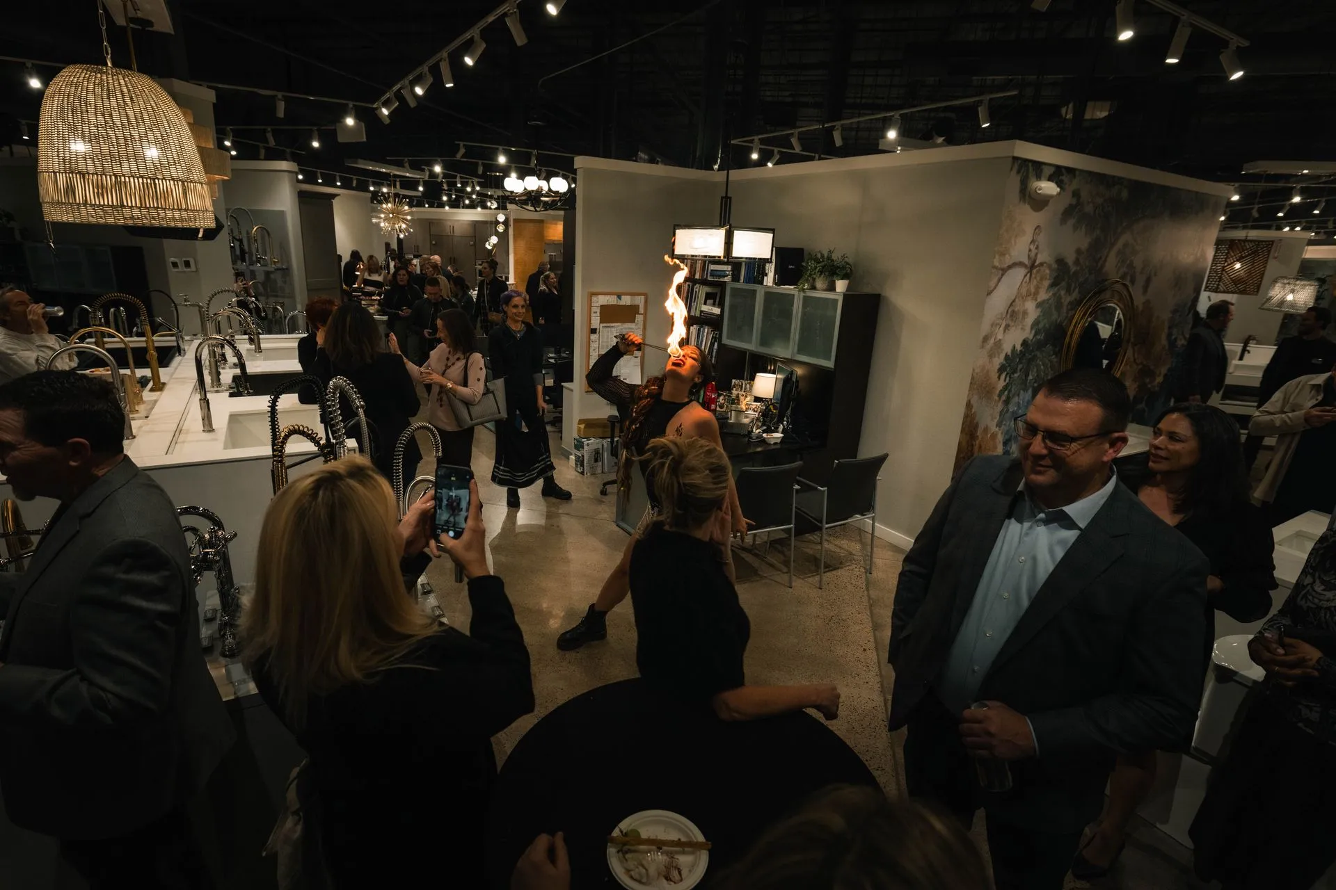 A large group of people are standing in a room.