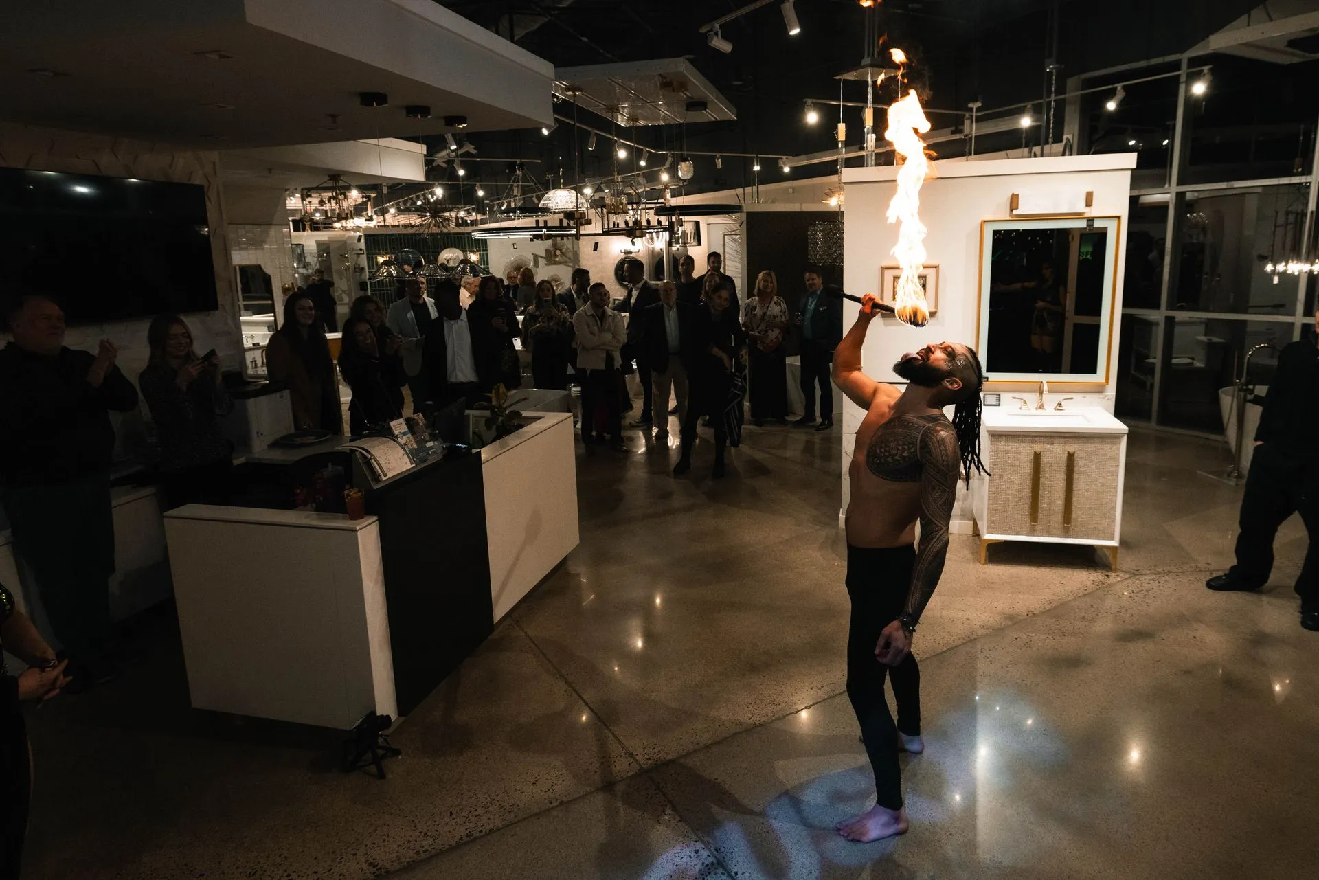 A man is holding a fireball in his mouth in a room.