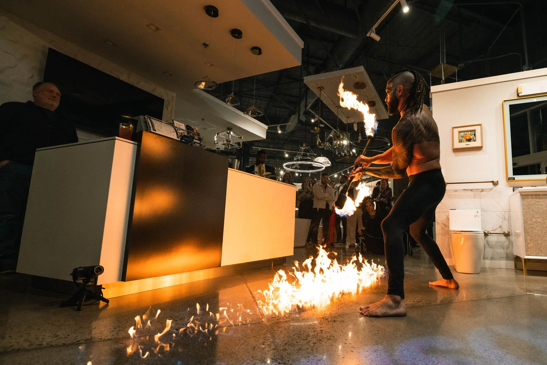 A group of people are playing with fire in a room.