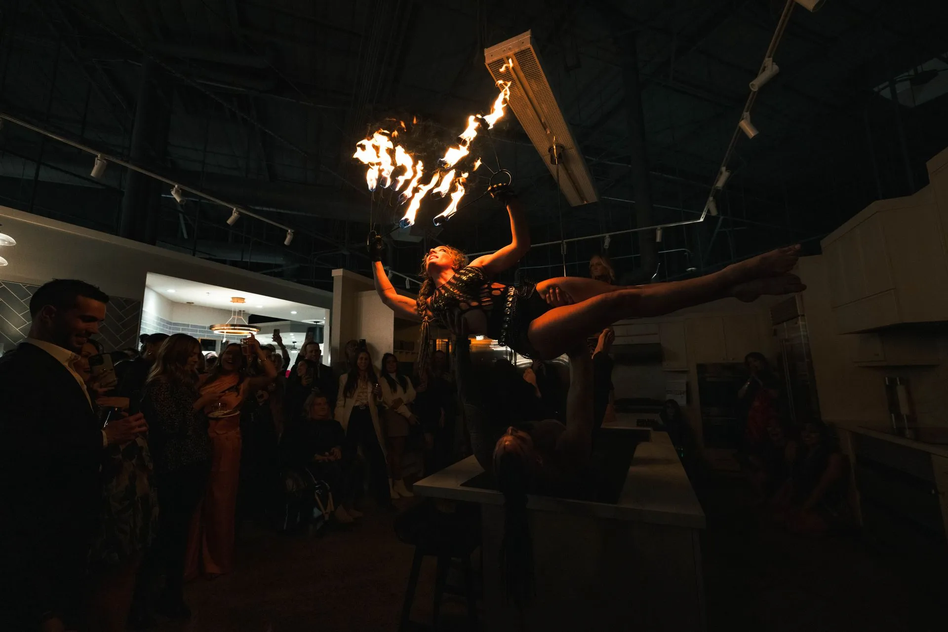 A woman is flying through the air while holding a torch.