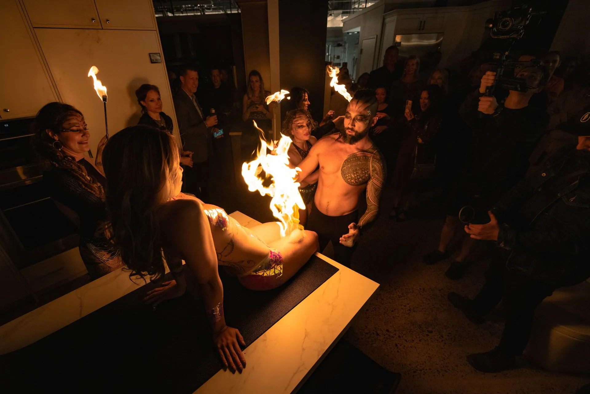 A man lighting a woman on fire.