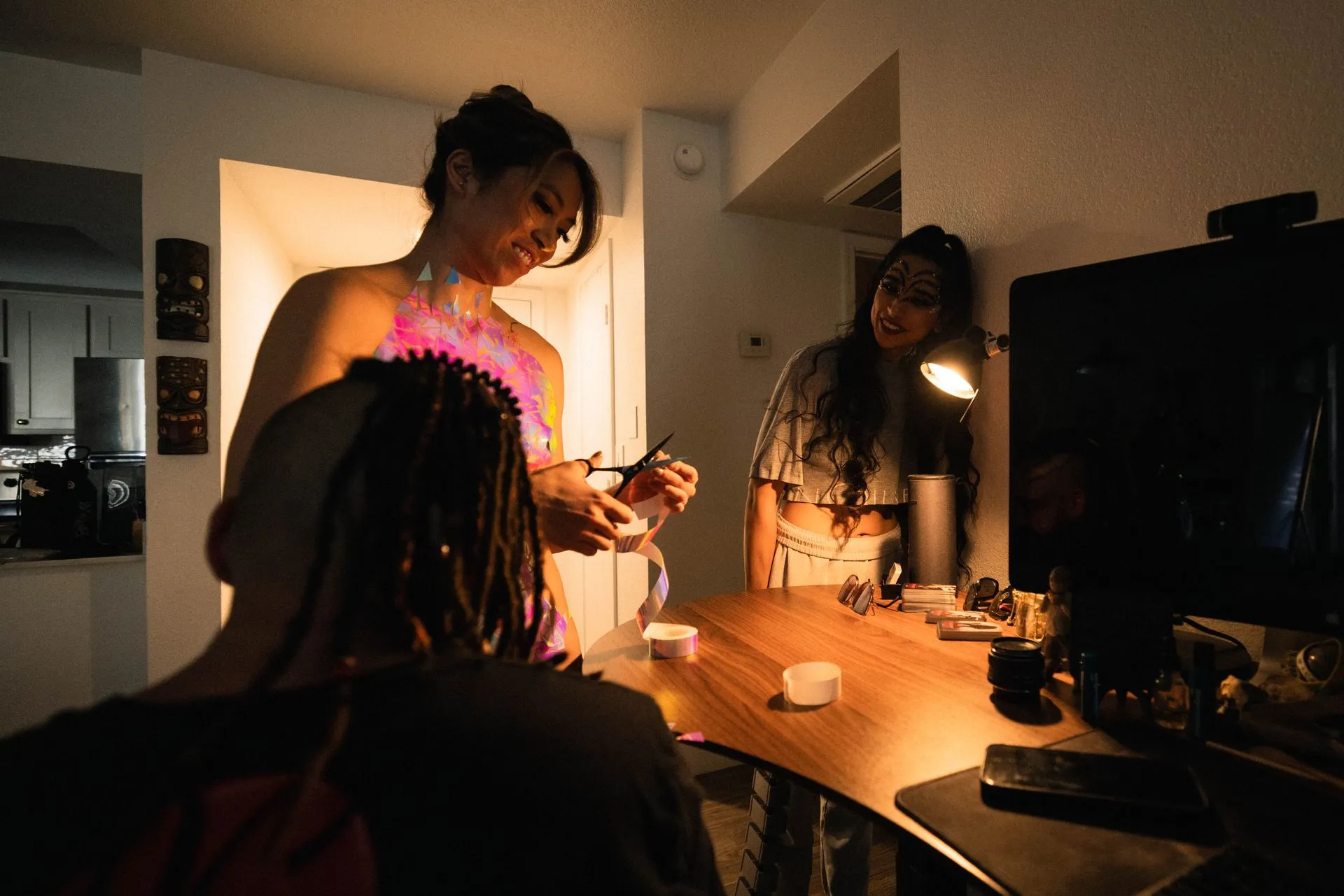 A group of people are standing around a table in a dark room.