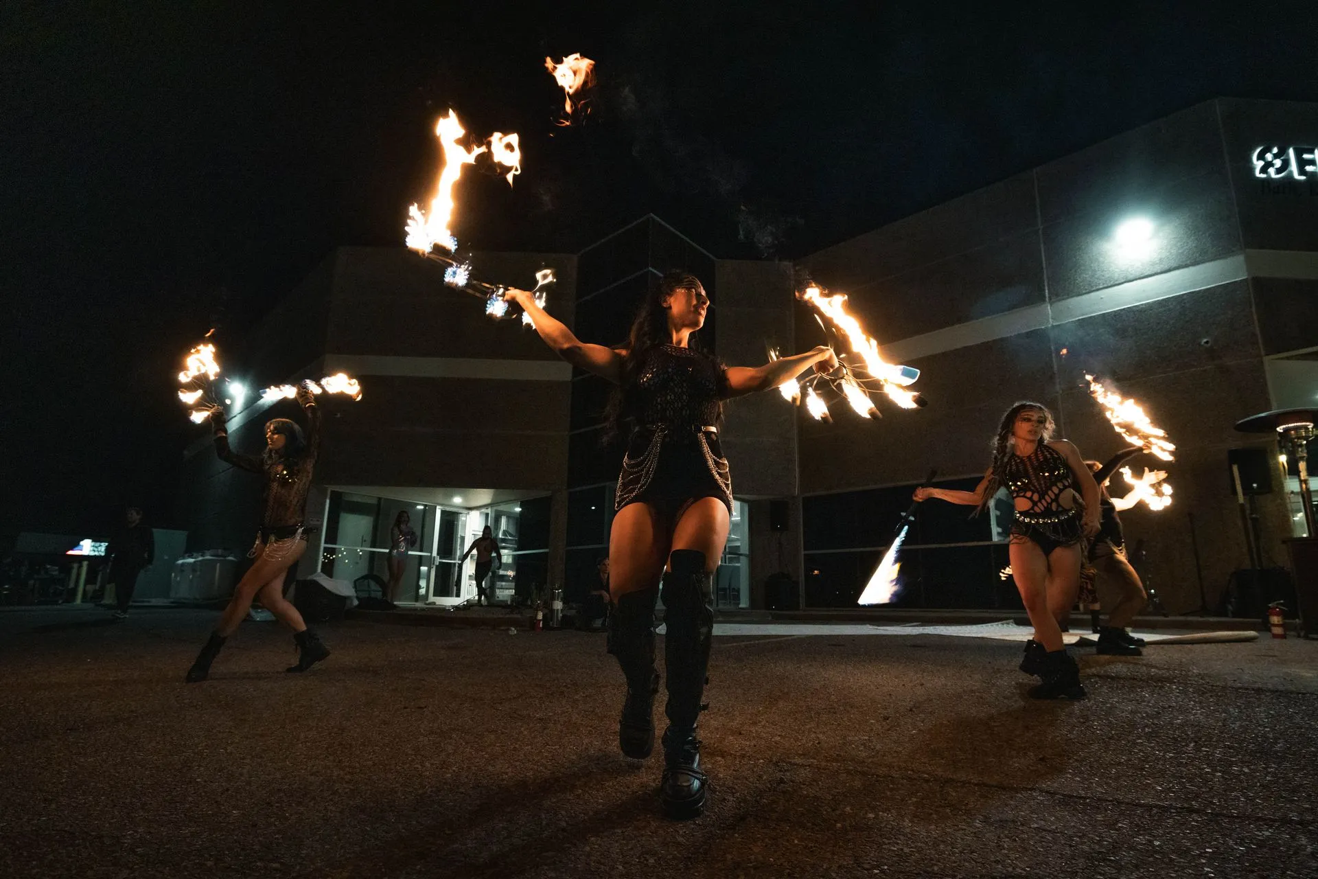 A group of people are dancing with fire in their hands.