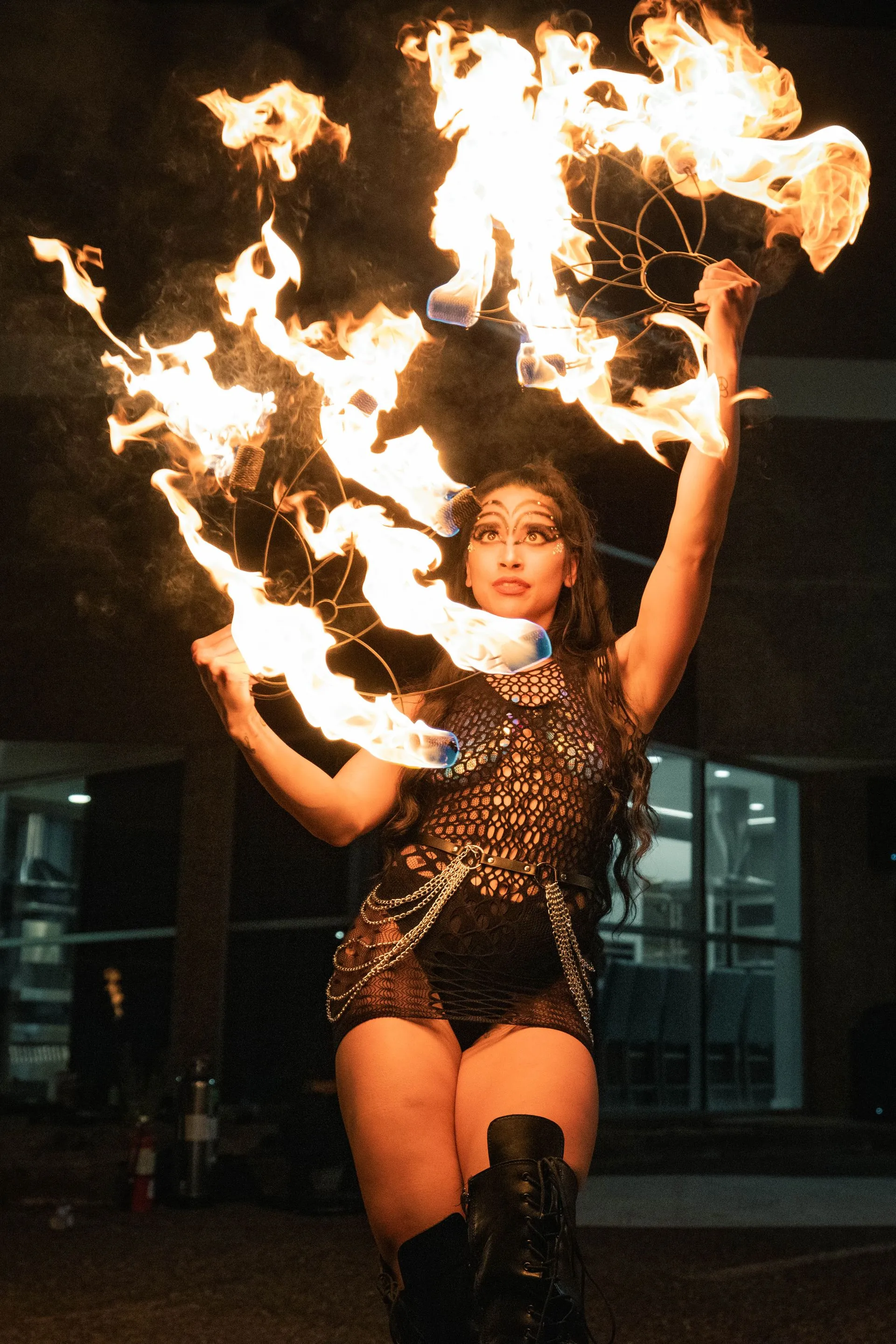 A woman is holding a torch full of flames