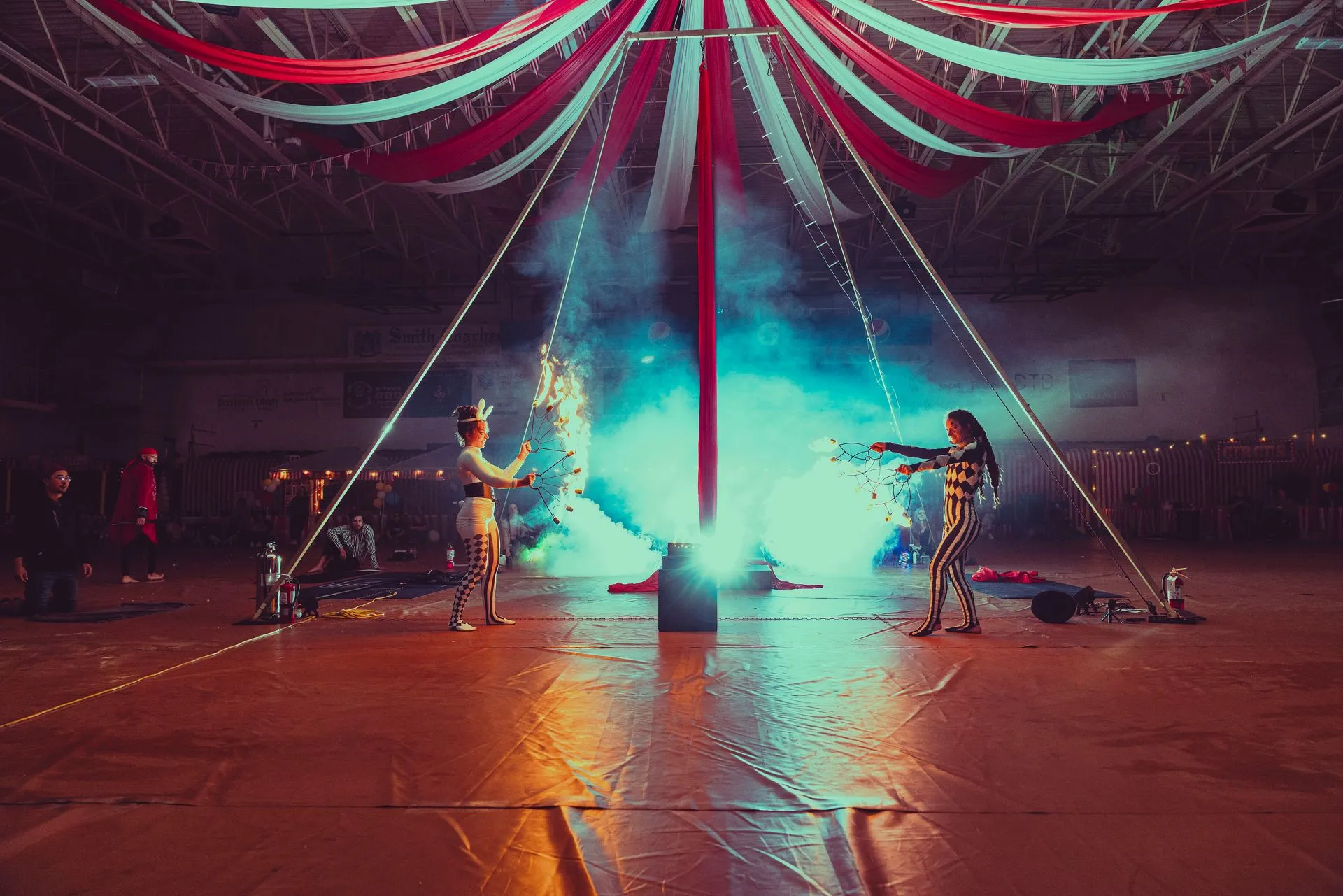 A couple of people are standing in front of a circus tent.
