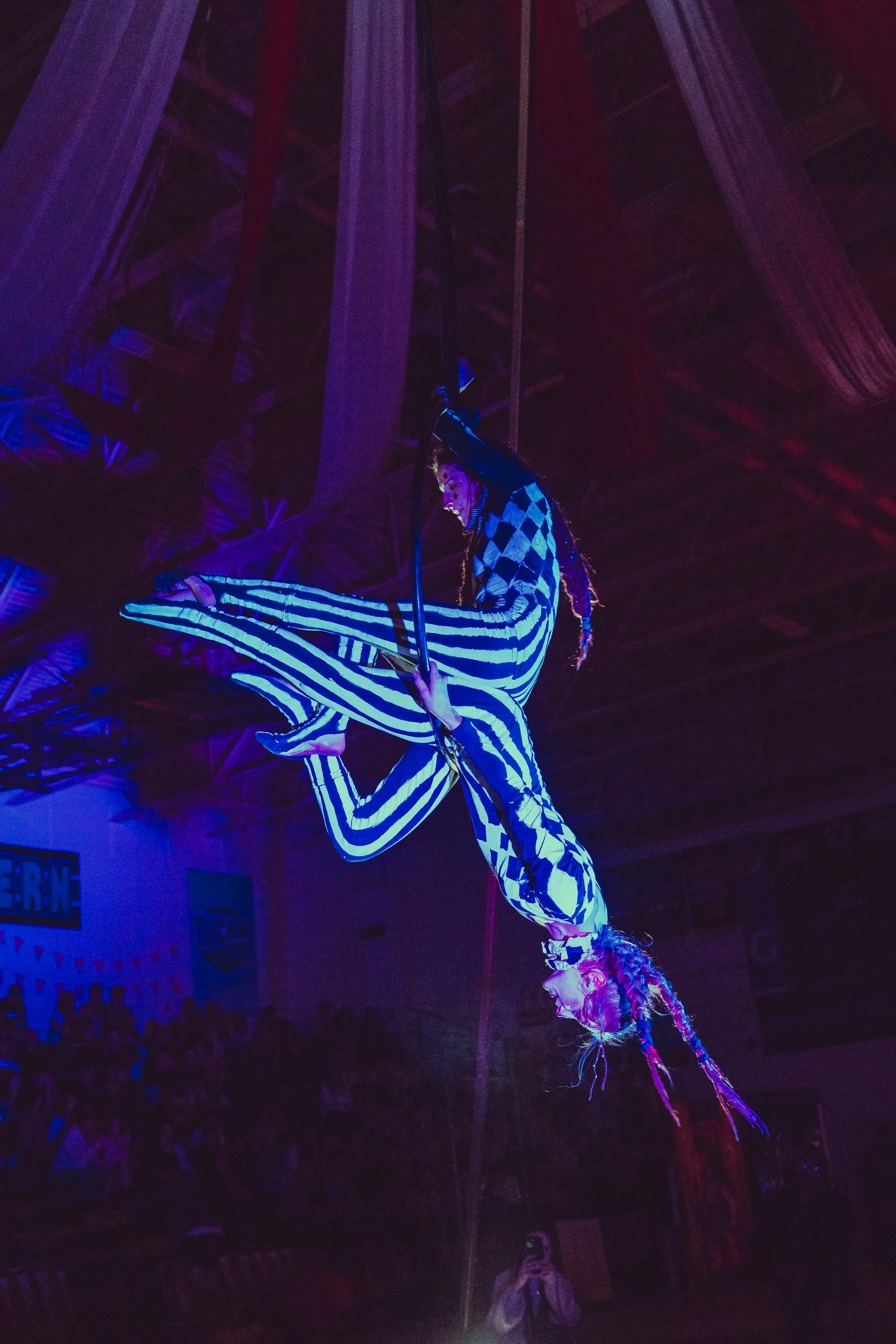 A woman in a striped outfit is flying through the air.