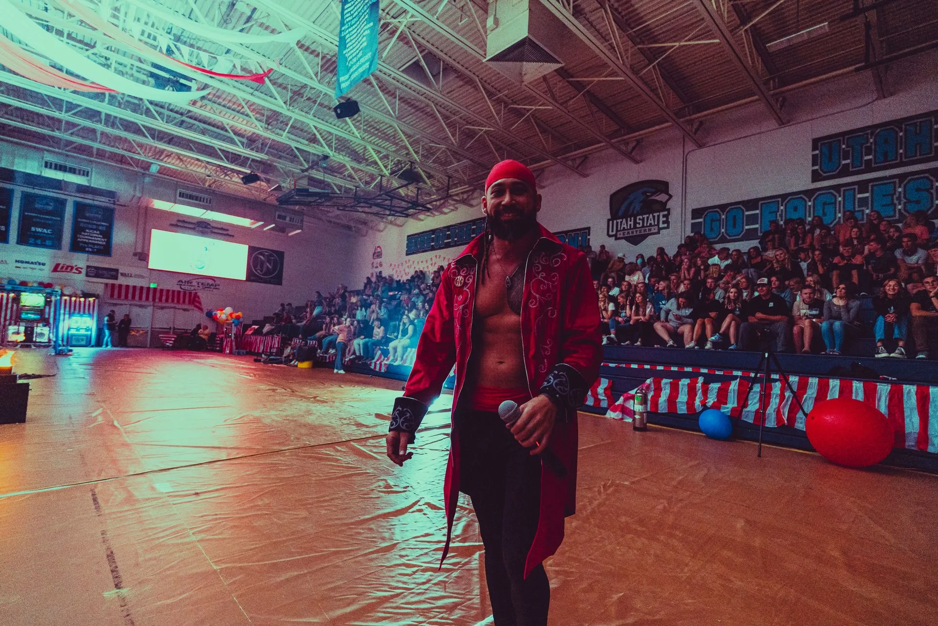 A man in a pirate costume is standing in front of a crowd in a stadium.