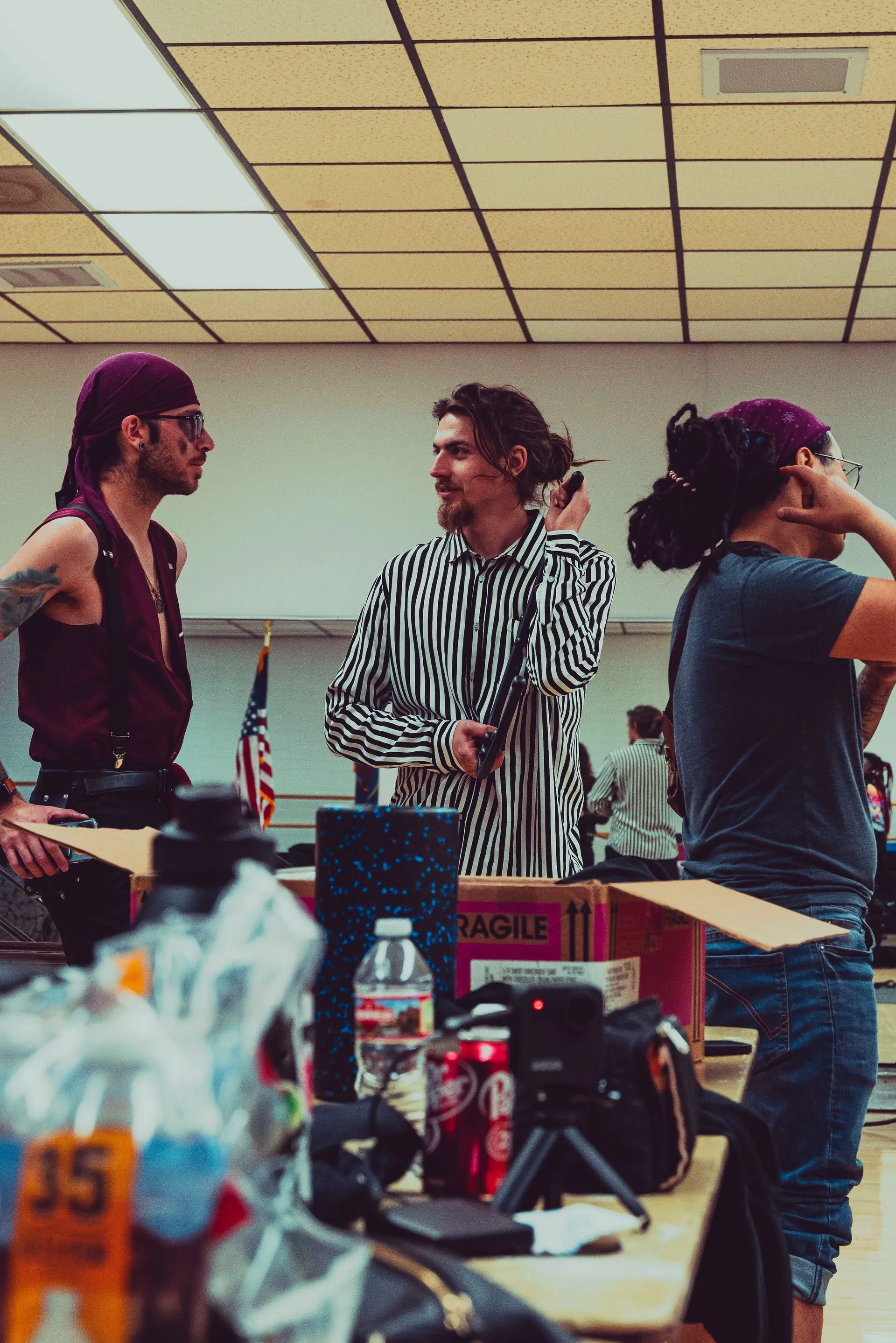 A group of people are standing around a table in a room.
