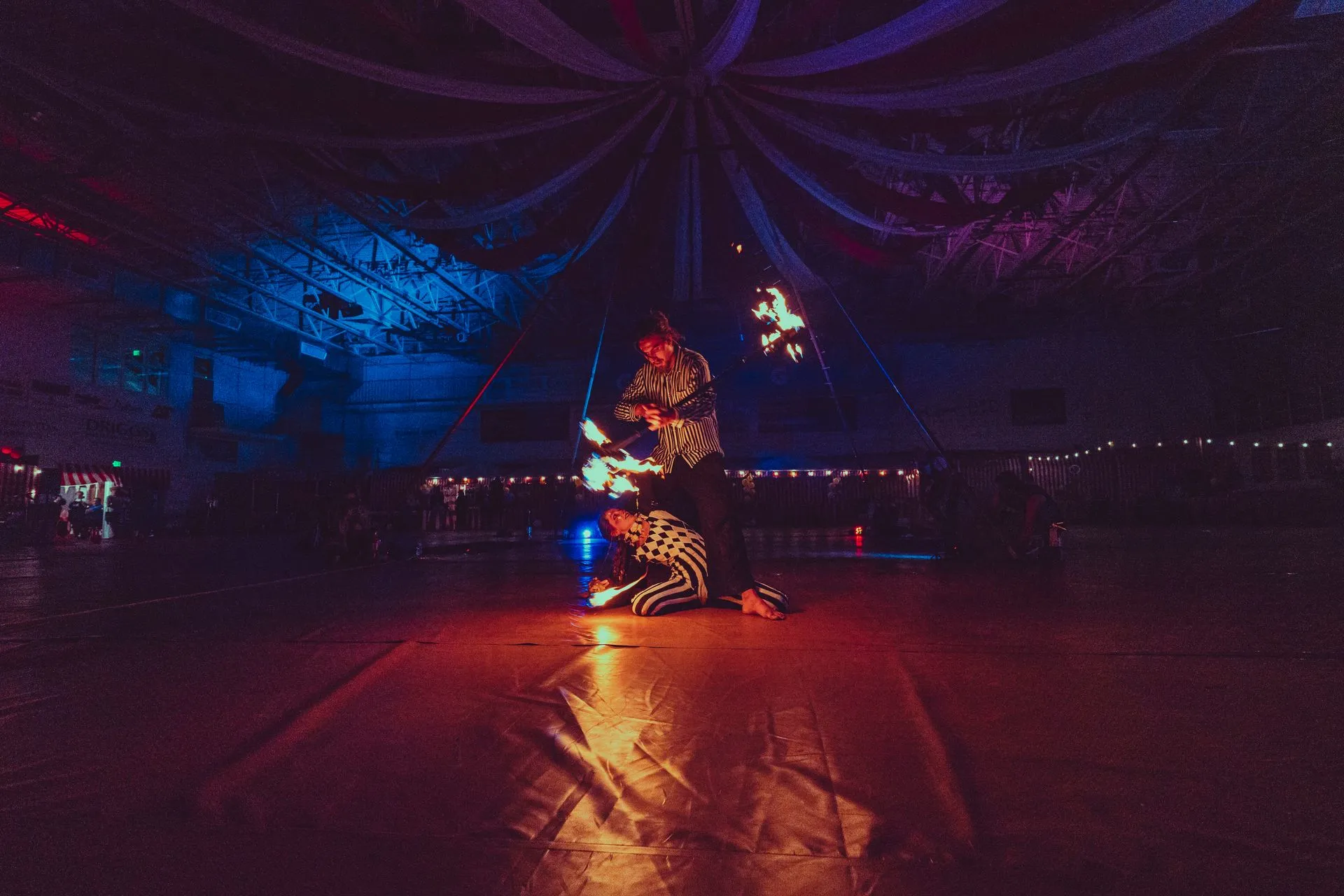 A couple of people are dancing on a dance floor in a dark room.