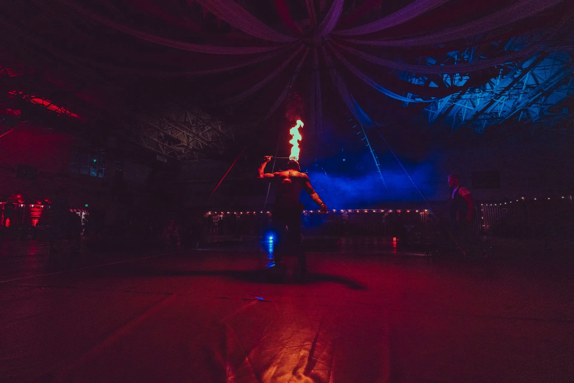 A person is holding a torch in a dark room.