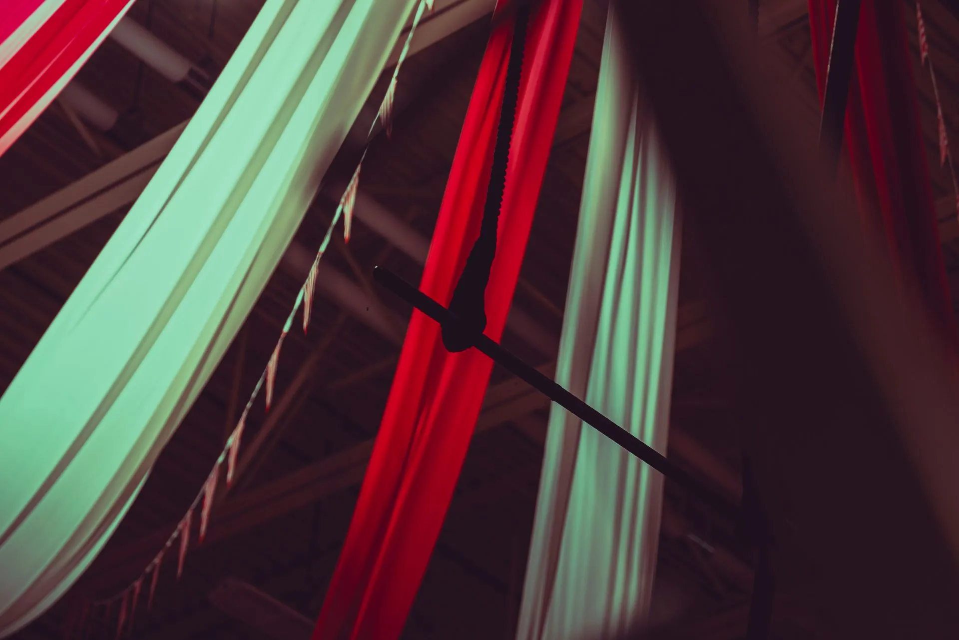 A bunch of colorful fabrics hanging from the ceiling