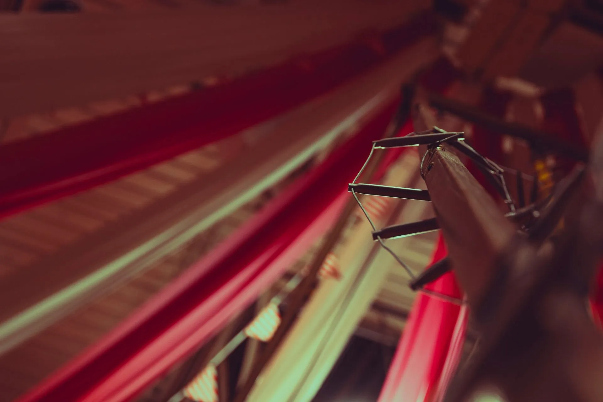 A close up of a red cloth hanging from the ceiling