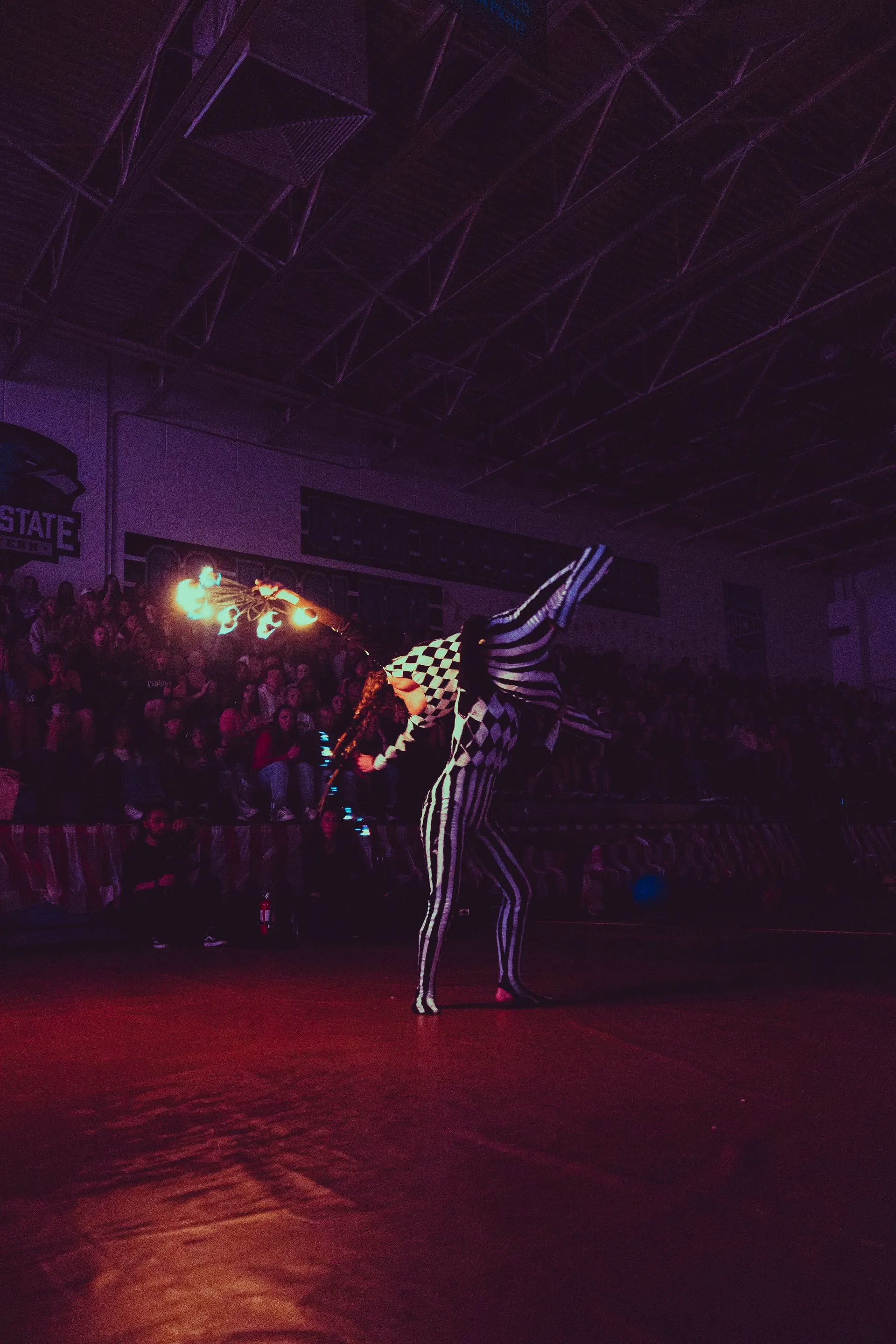 A couple of people are dancing in a dark room.