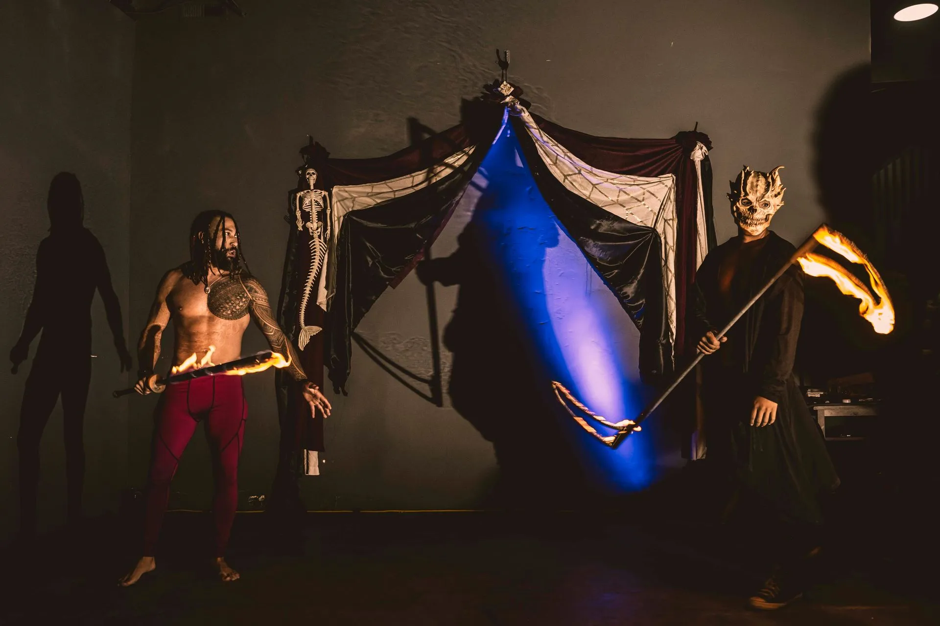 A man fighting the grim reaper with a fire sword.