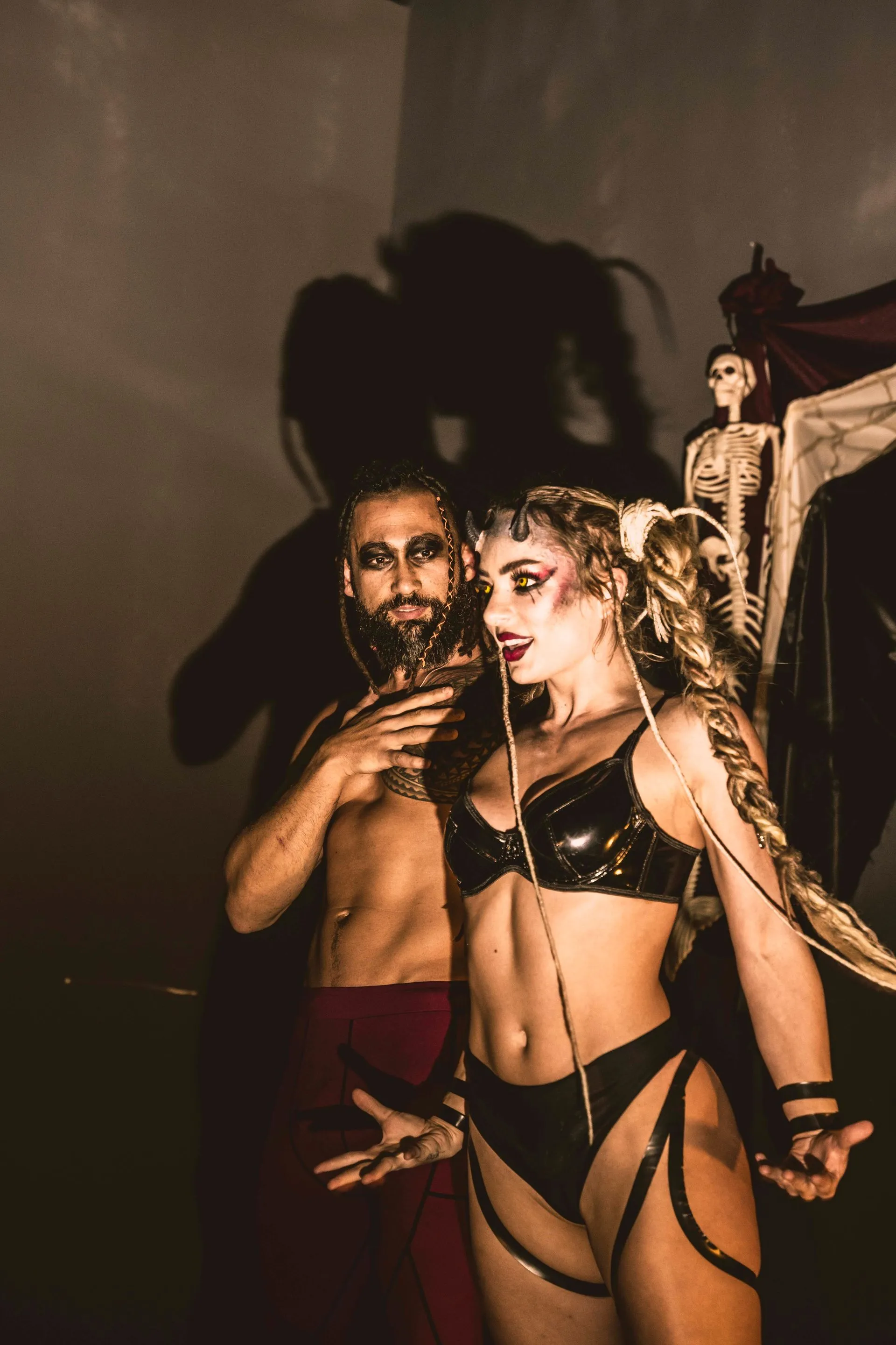 A man and a woman are standing next to each other in a dark room.