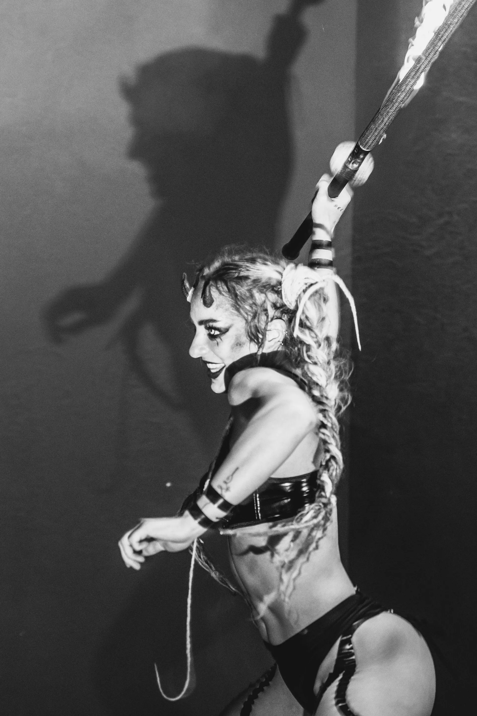 A black and white photo of a woman holding a bat