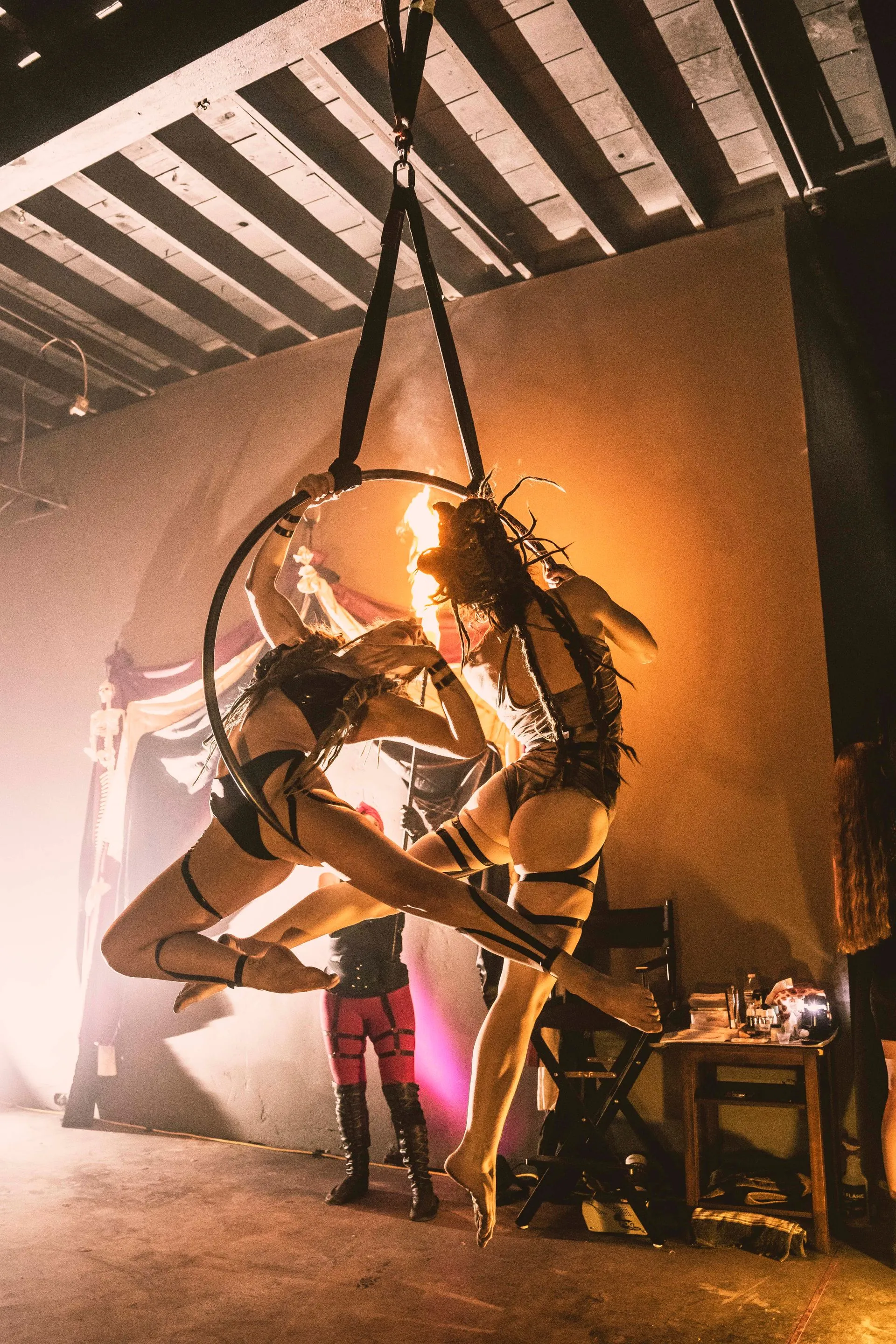 Two woman performing duo Lyra in the air.