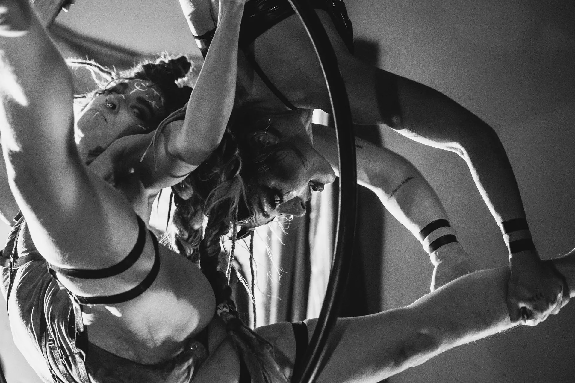 A black and white photo of a woman doing aerial acrobatics