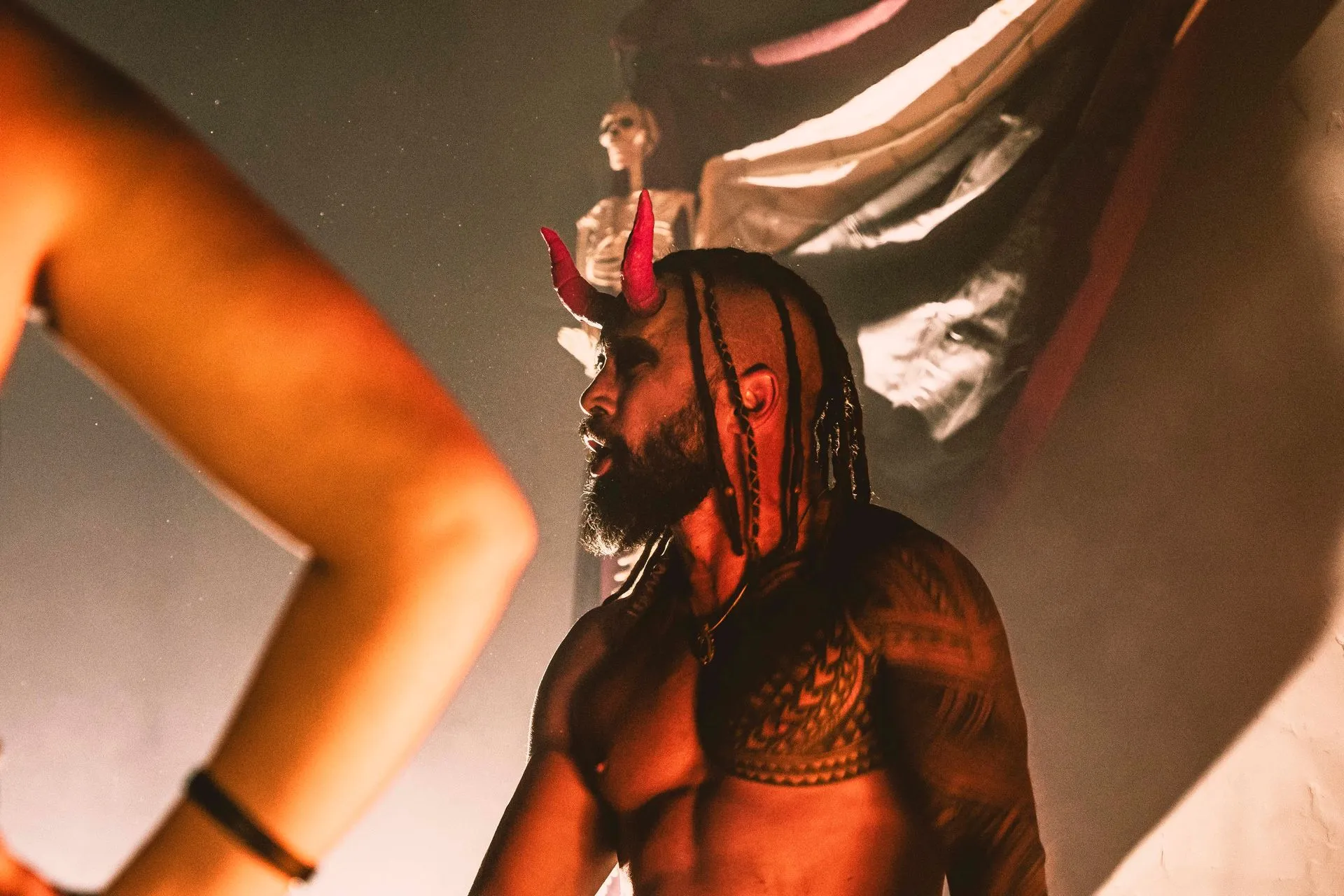 A man with devil horns yelling.