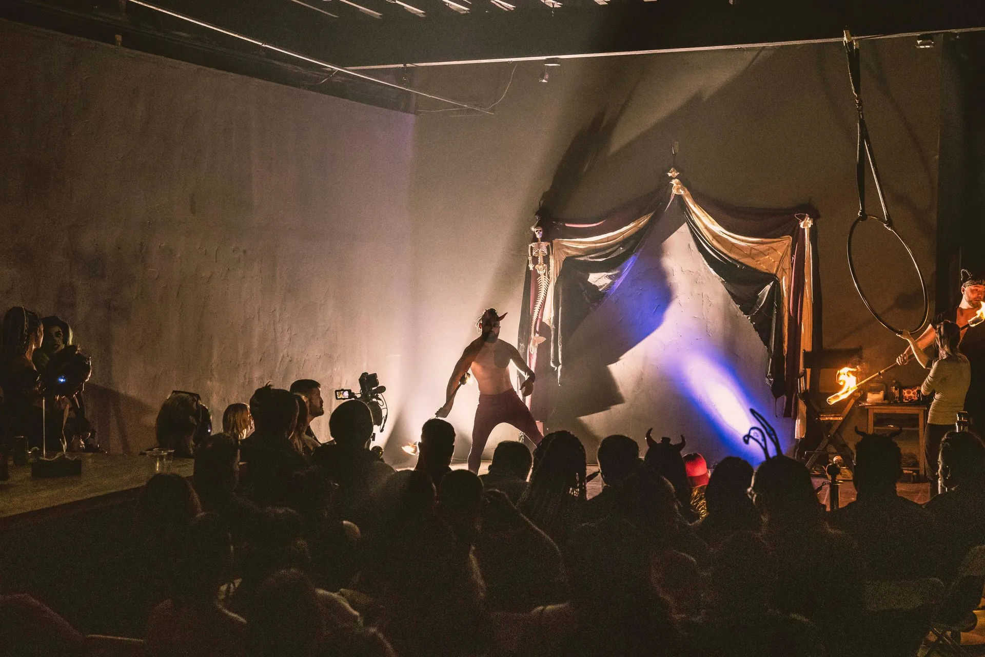 A man is standing on a stage in front of a crowd of people.