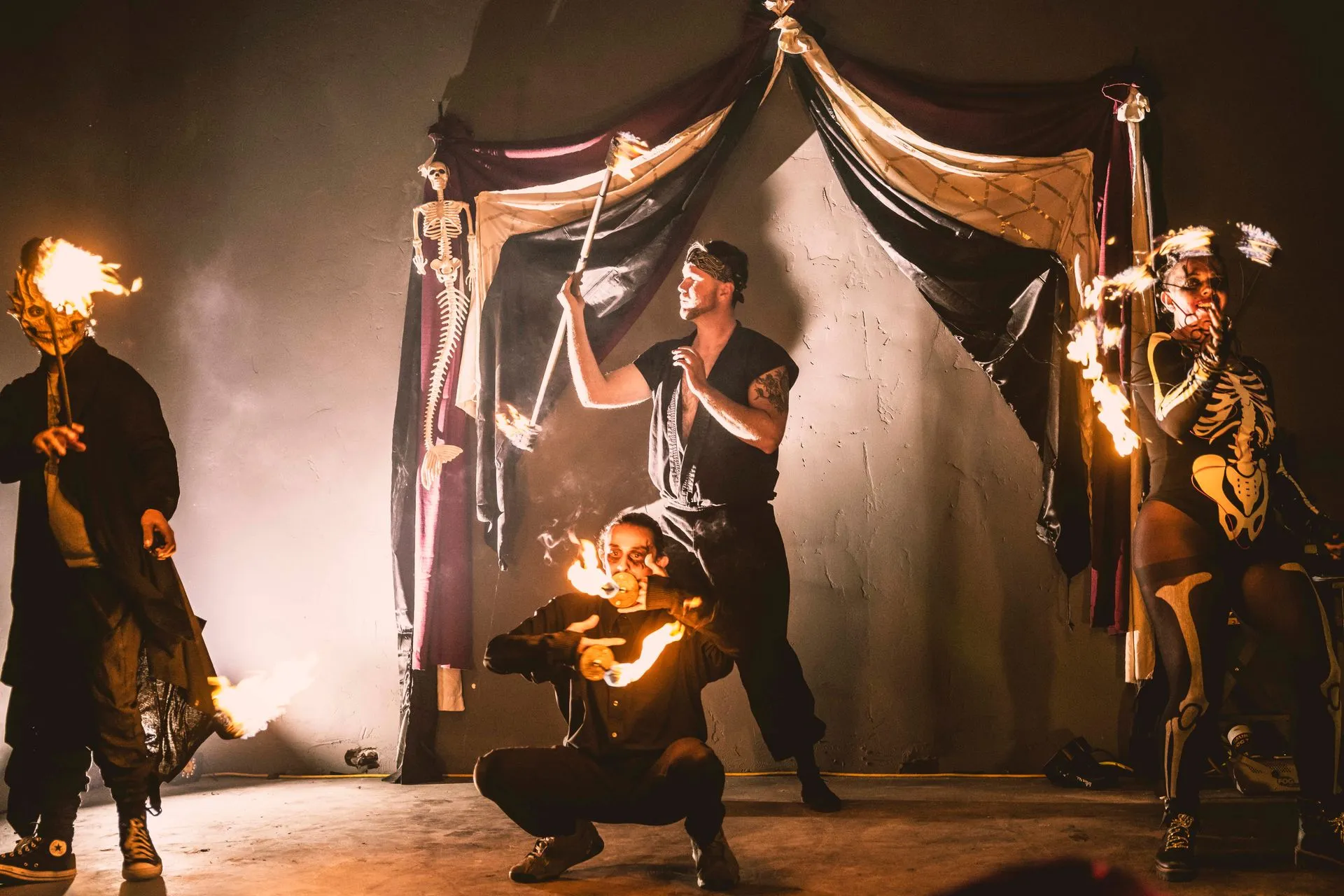 A group of people are performing a fire show on a stage.