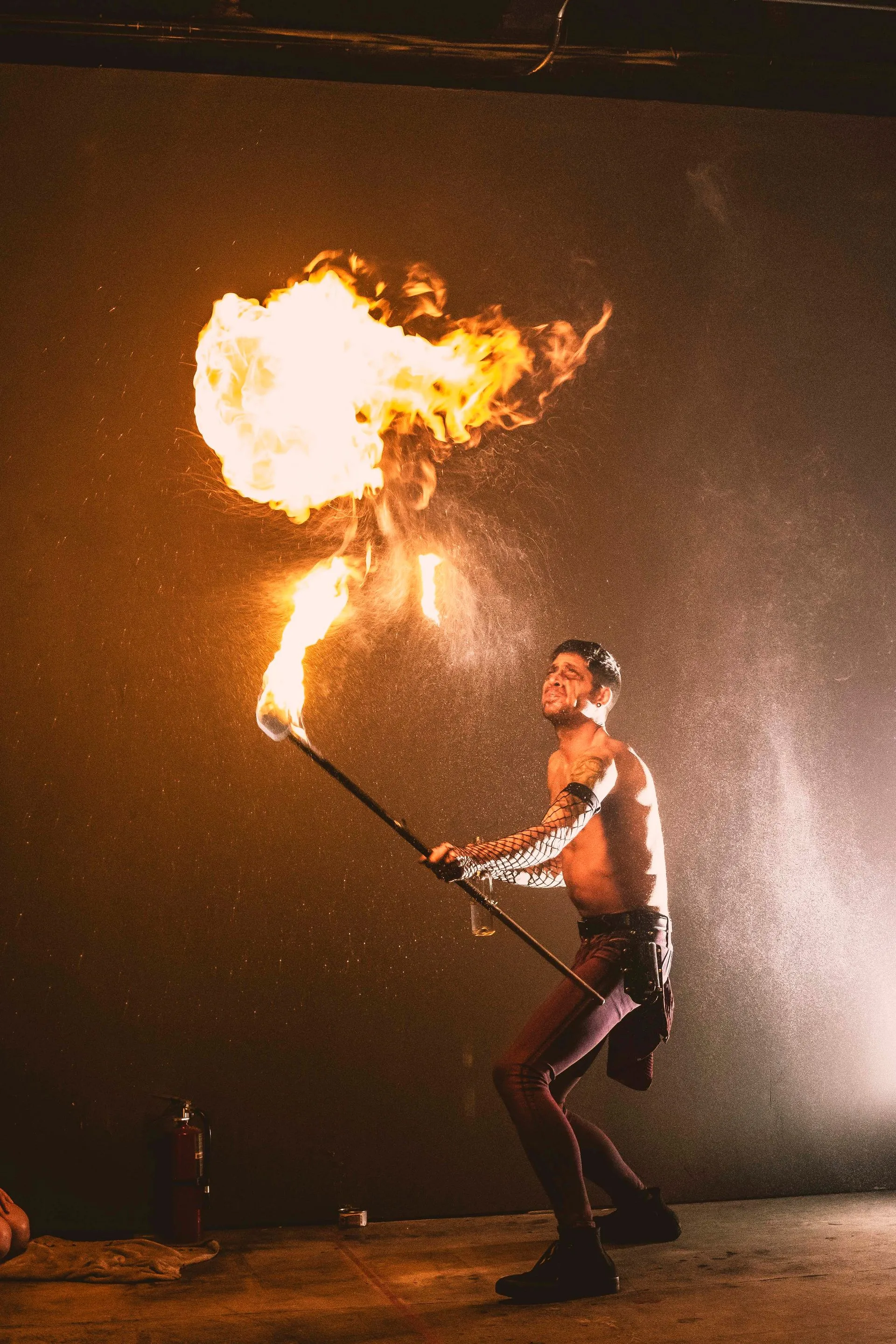 A man is breathing fire.
