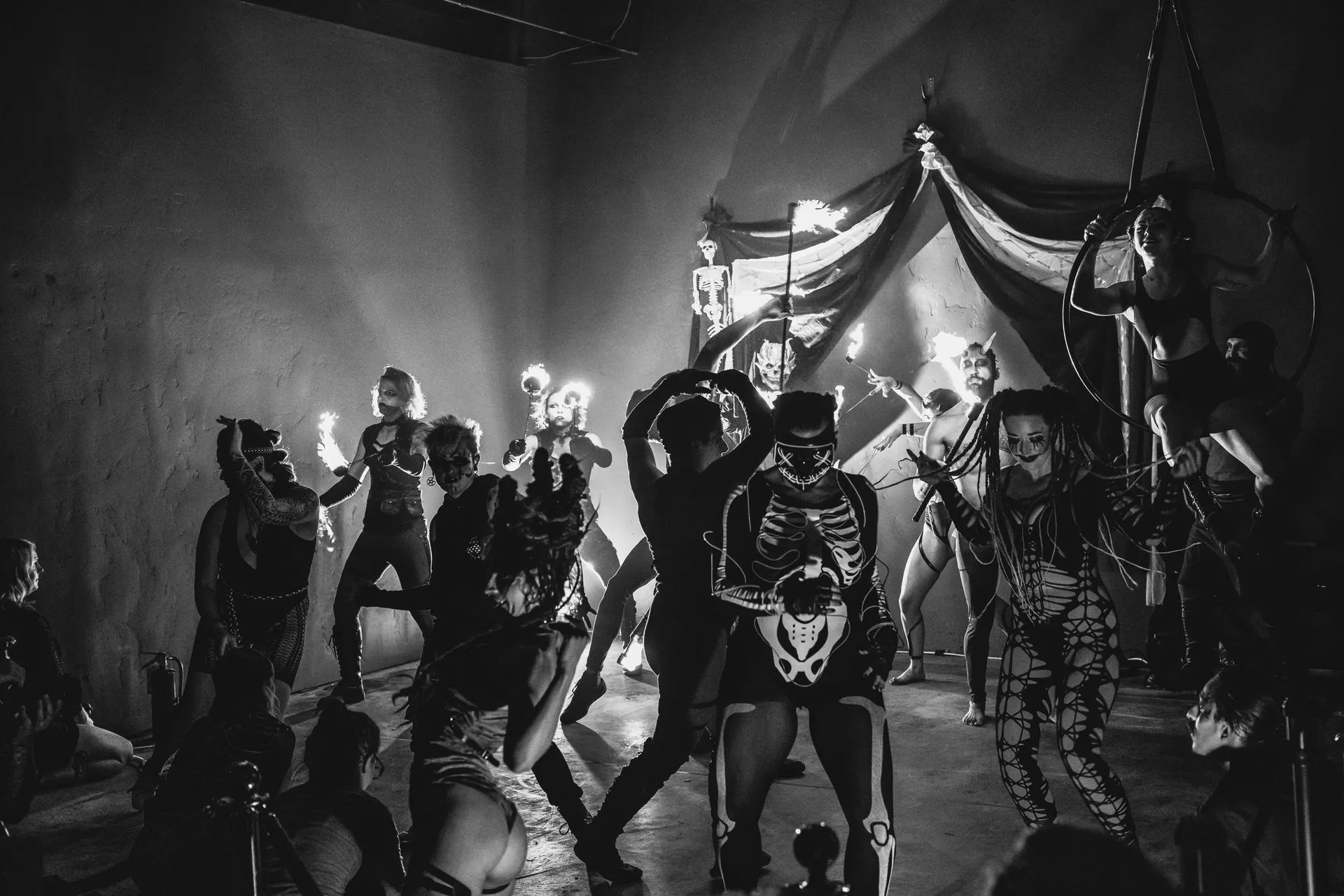A group of people dressed as skeletons are dancing on a stage.