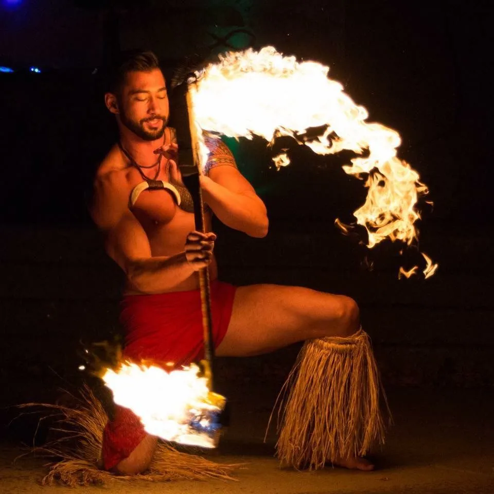 A man is holding a torch with flames coming out of it