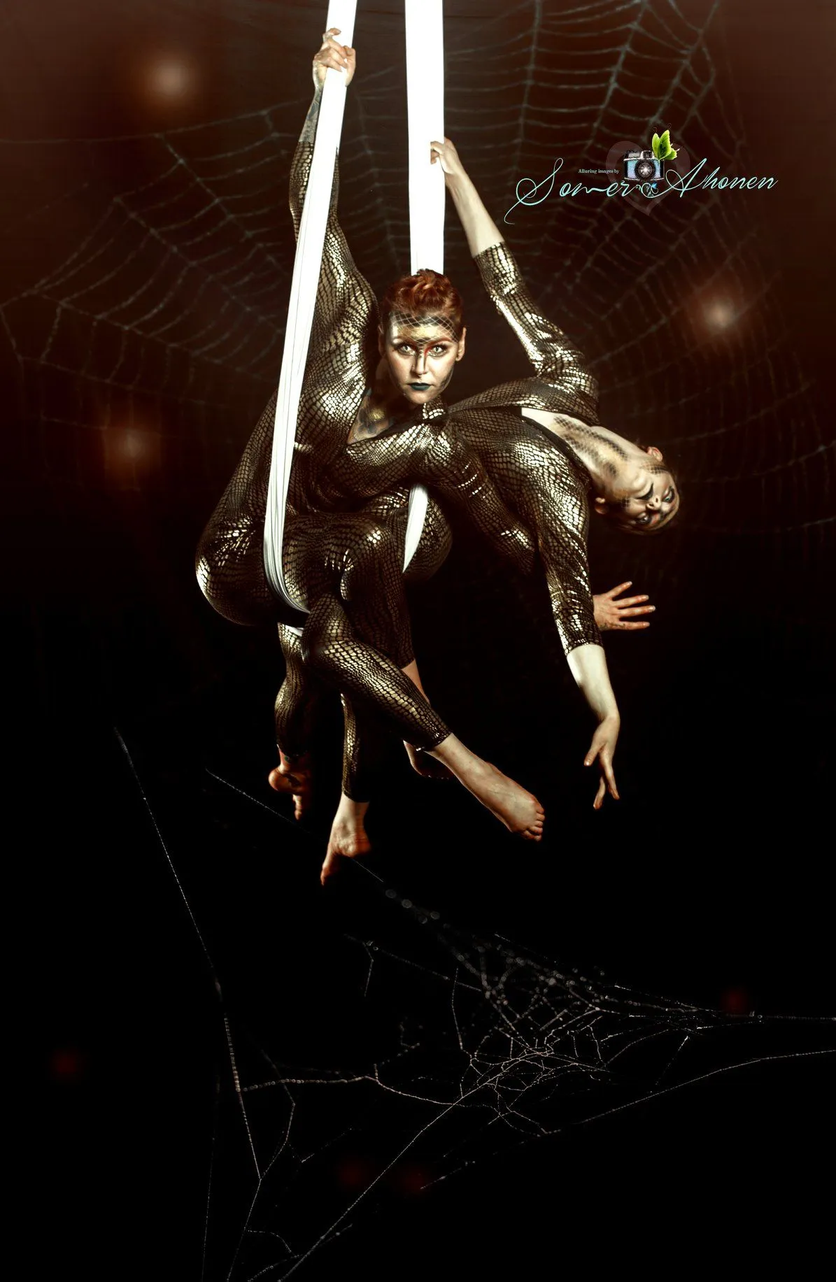 A couple of people are hanging upside down in the air.