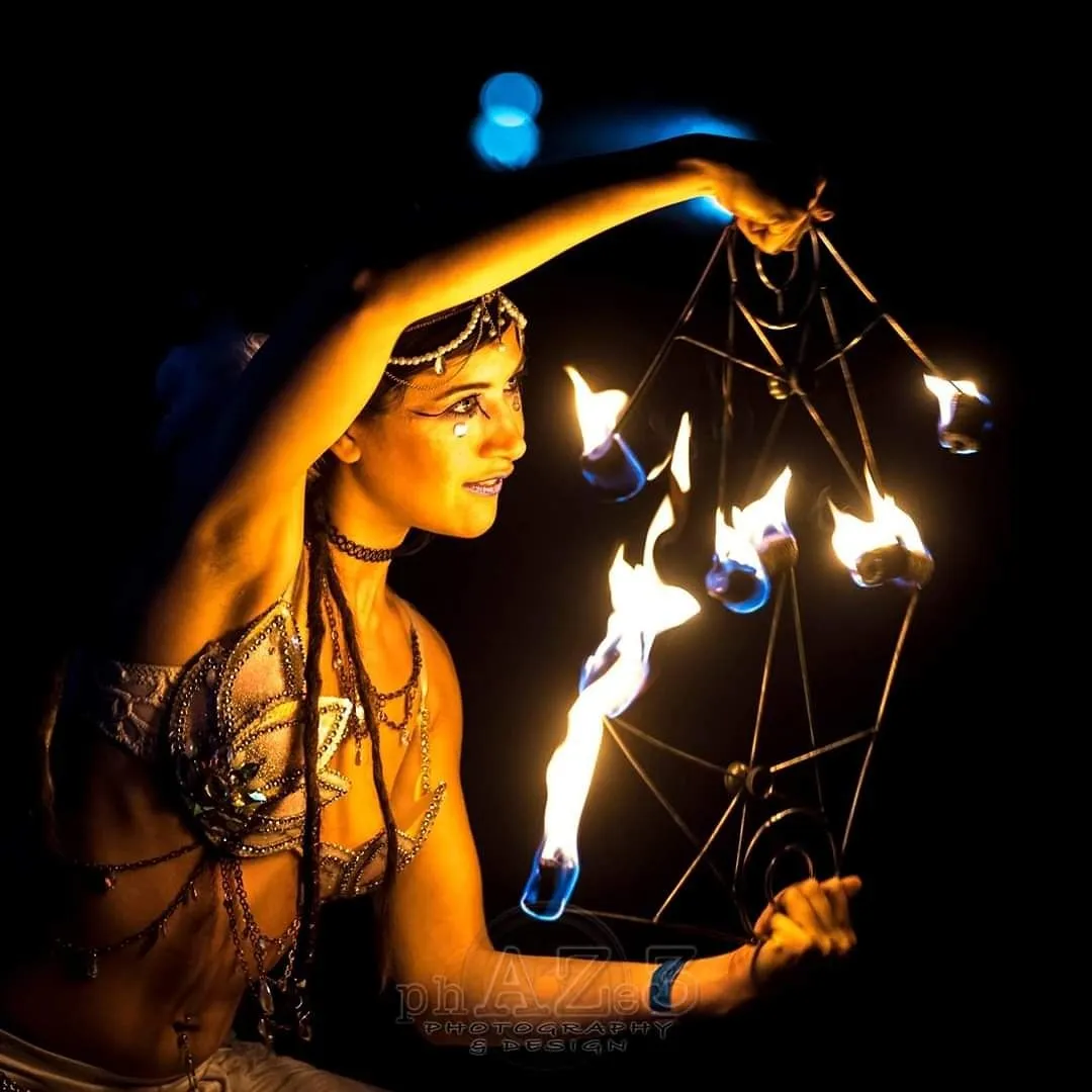 A woman is holding a torch with flames coming out of it