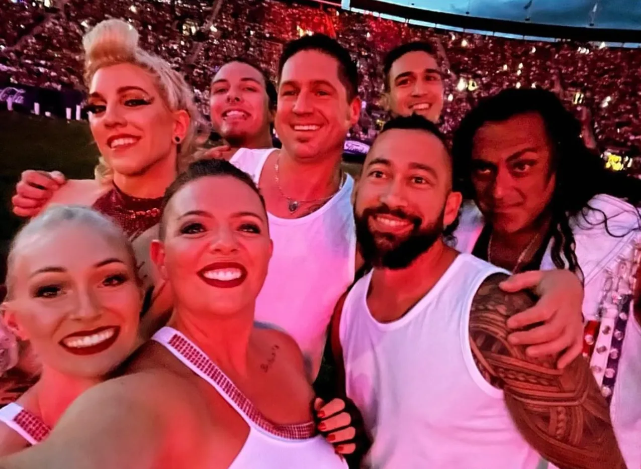 A group of people posing for a picture in a stadium