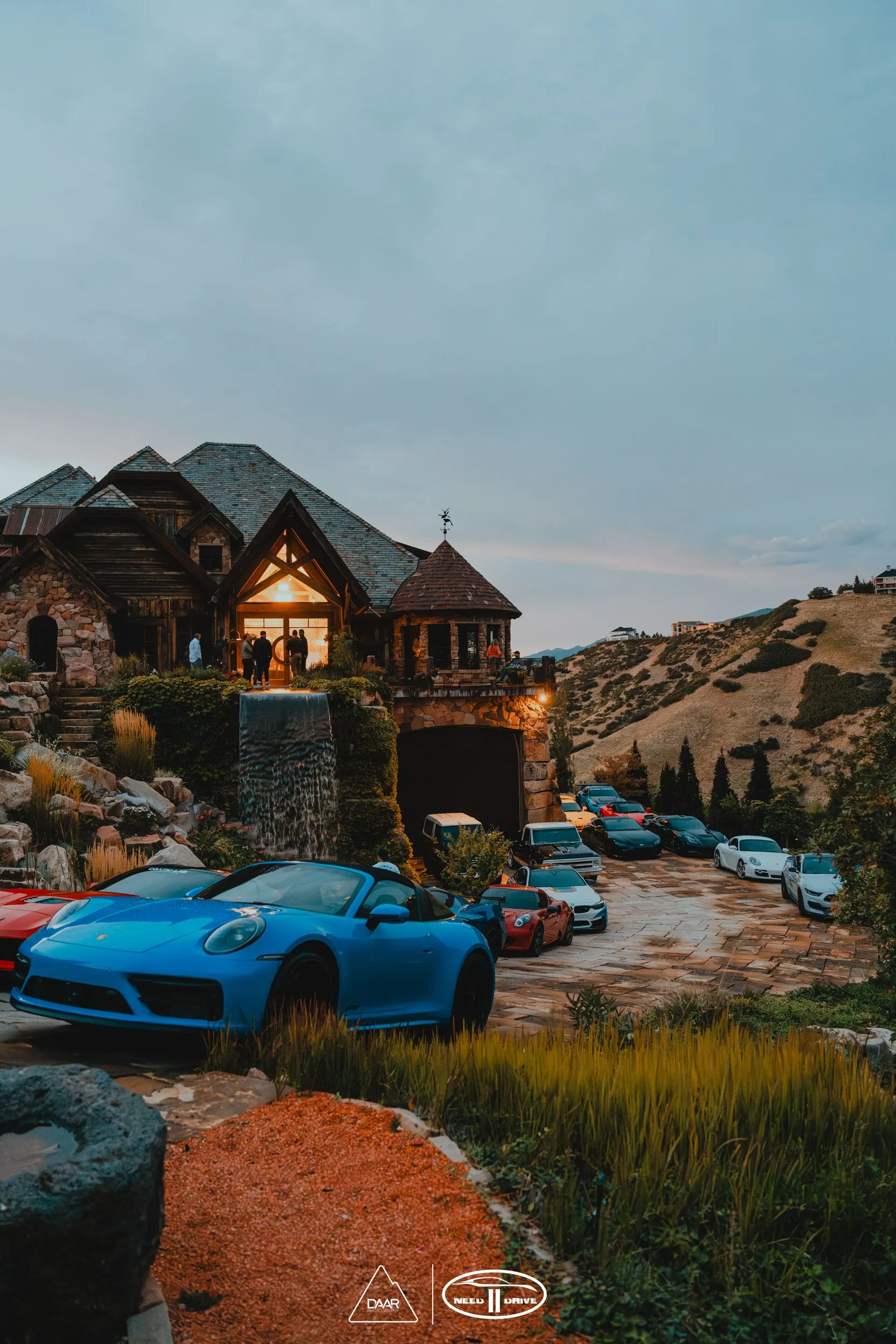 A bunch of cars are parked in front of a house.