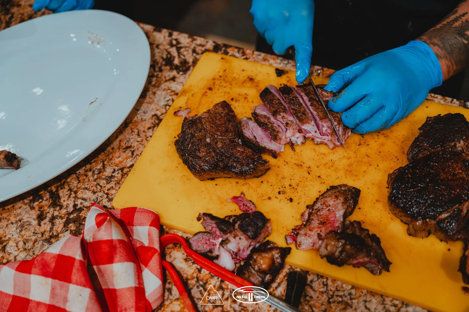 A person is cutting meat on a cutting board.