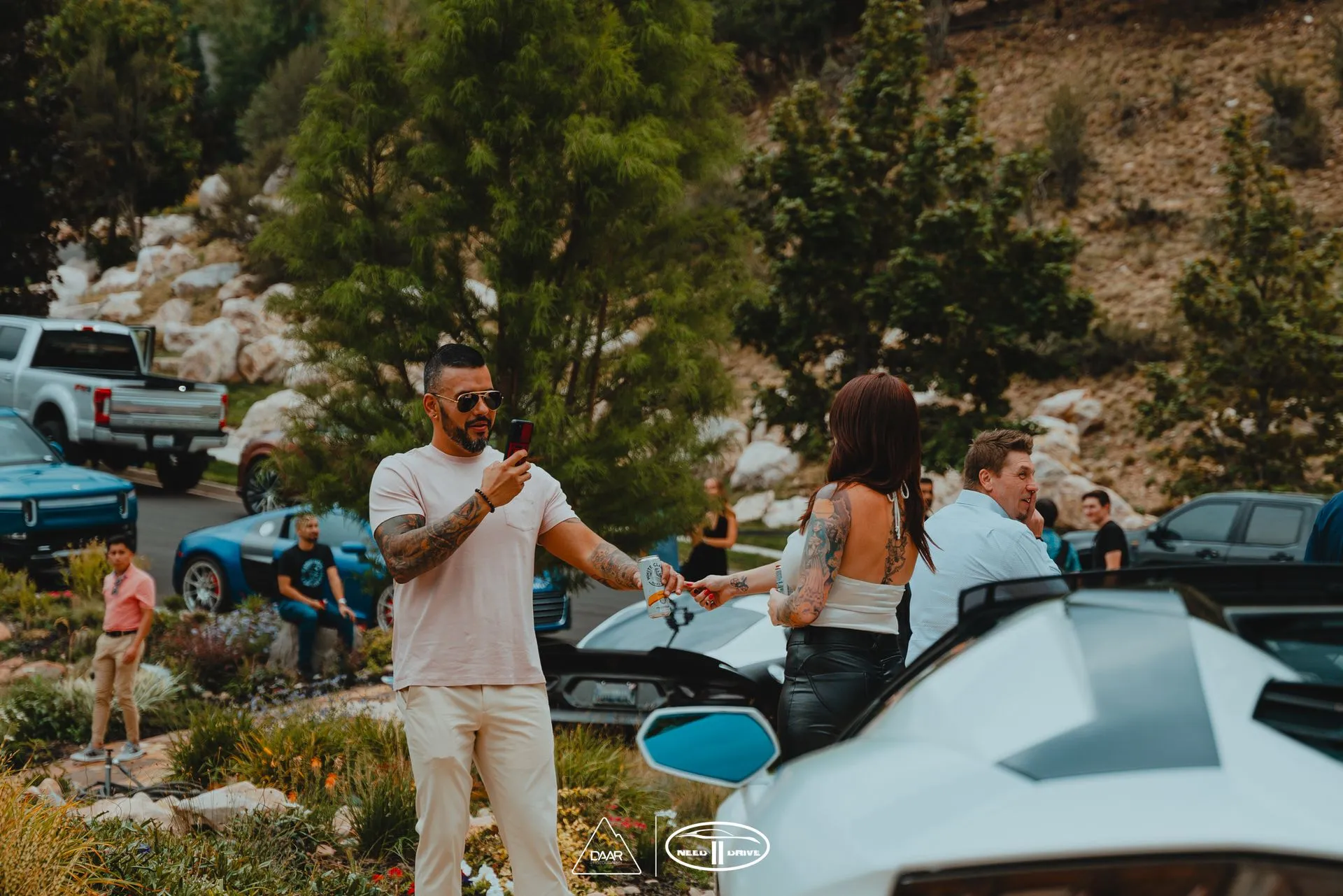 A man is holding a woman 's hand while standing next to a car.