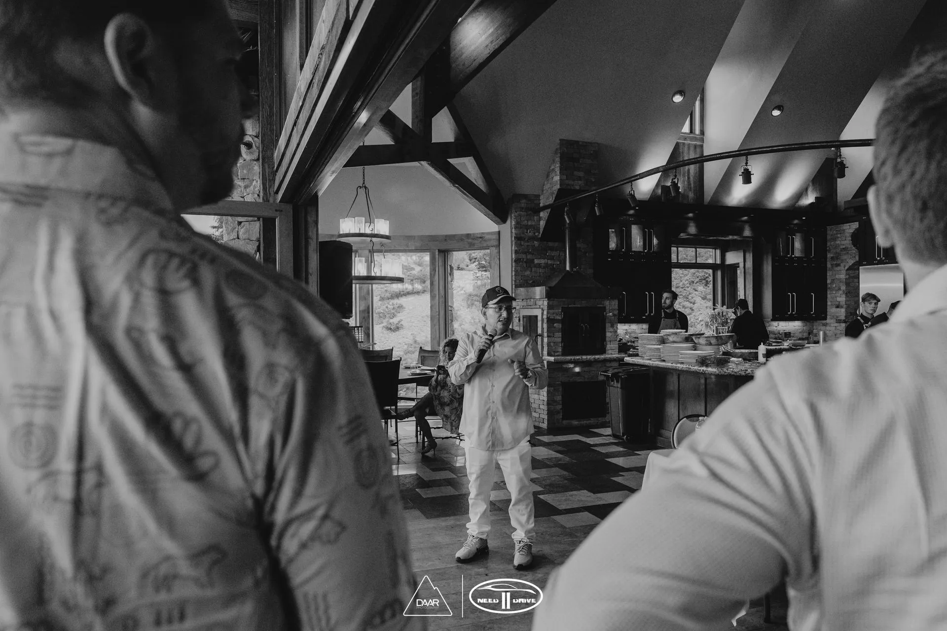 A black and white photo of two men standing in a room.
