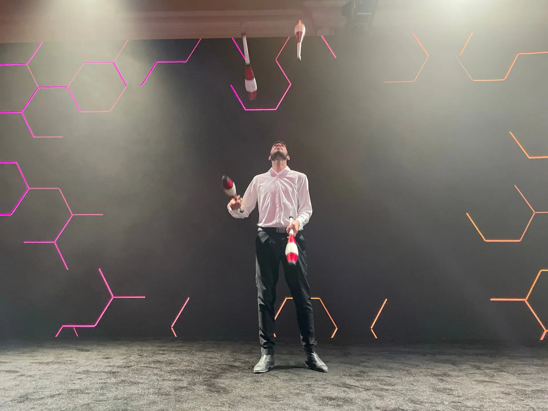 A man wearing a virtual reality headset is holding a bottle of champagne.