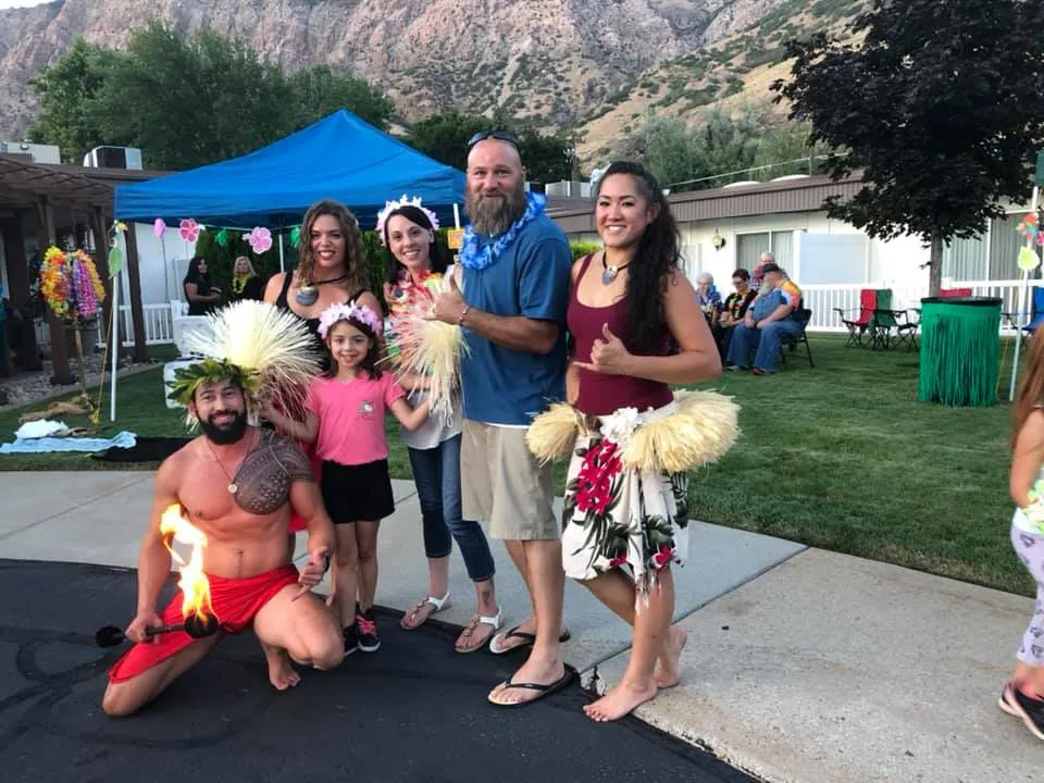 A group of people are posing for a picture in front of a blue tent.