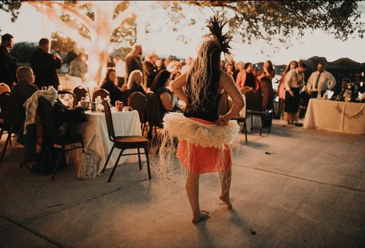 A woman is dancing in front of a crowd of people